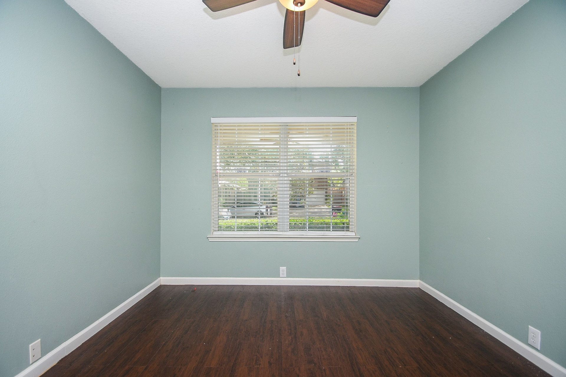 10222 Antelope Alley, Missouri City, TX 77459 Soothing green wall paint and a large window inviting natural light, complemented by a ceiling fan for comfort.
