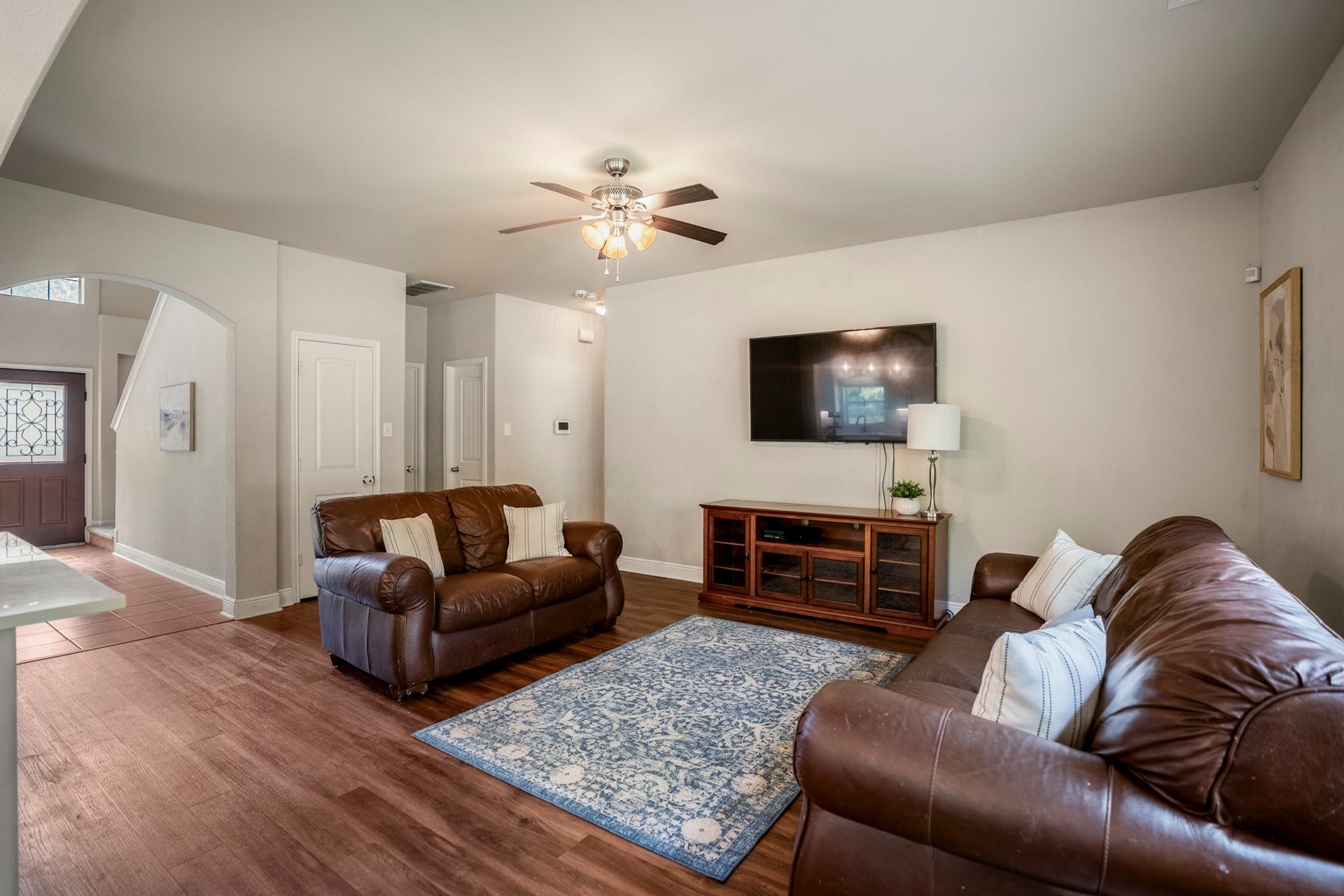 942 Oak Glen Drive, Conroe, TX 77378 This angle shows the living room opening just beyond the kitchen and breakfast area, giving everyone a comfortable place to gather without feeling removed from whats happening nearby. Vinyl plank flooring continues through the space, while windows along the exterior wall pull in natural light and backyard views.