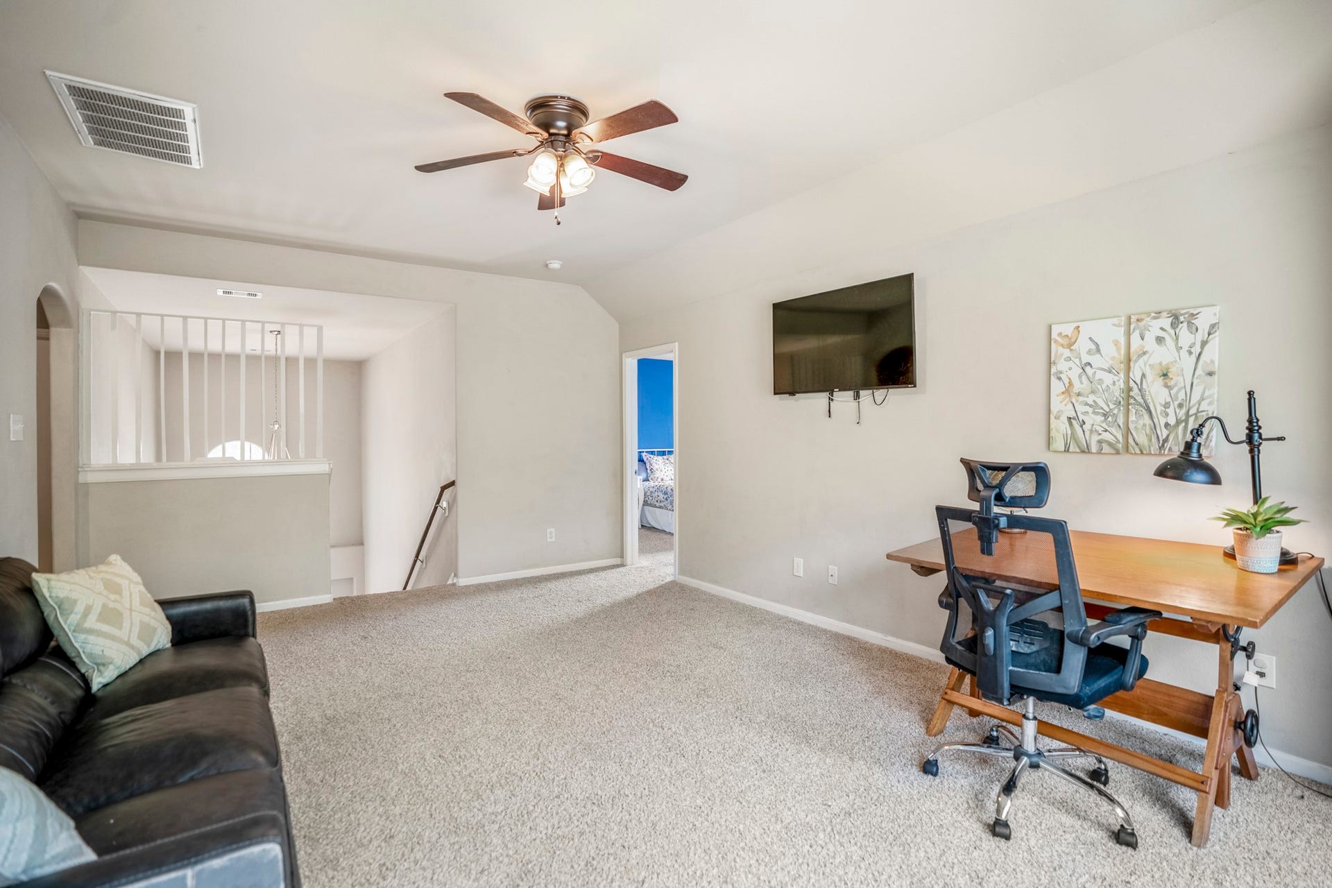 942 Oak Glen Drive, Conroe, TX 77378 From the opposite side, the gameroom feels open and flexible, with plenty of natural light and room to spread out. The doorway on the left leads toward the secondary bedroom well visit next, while the rest of the upstairs remains just beyond.