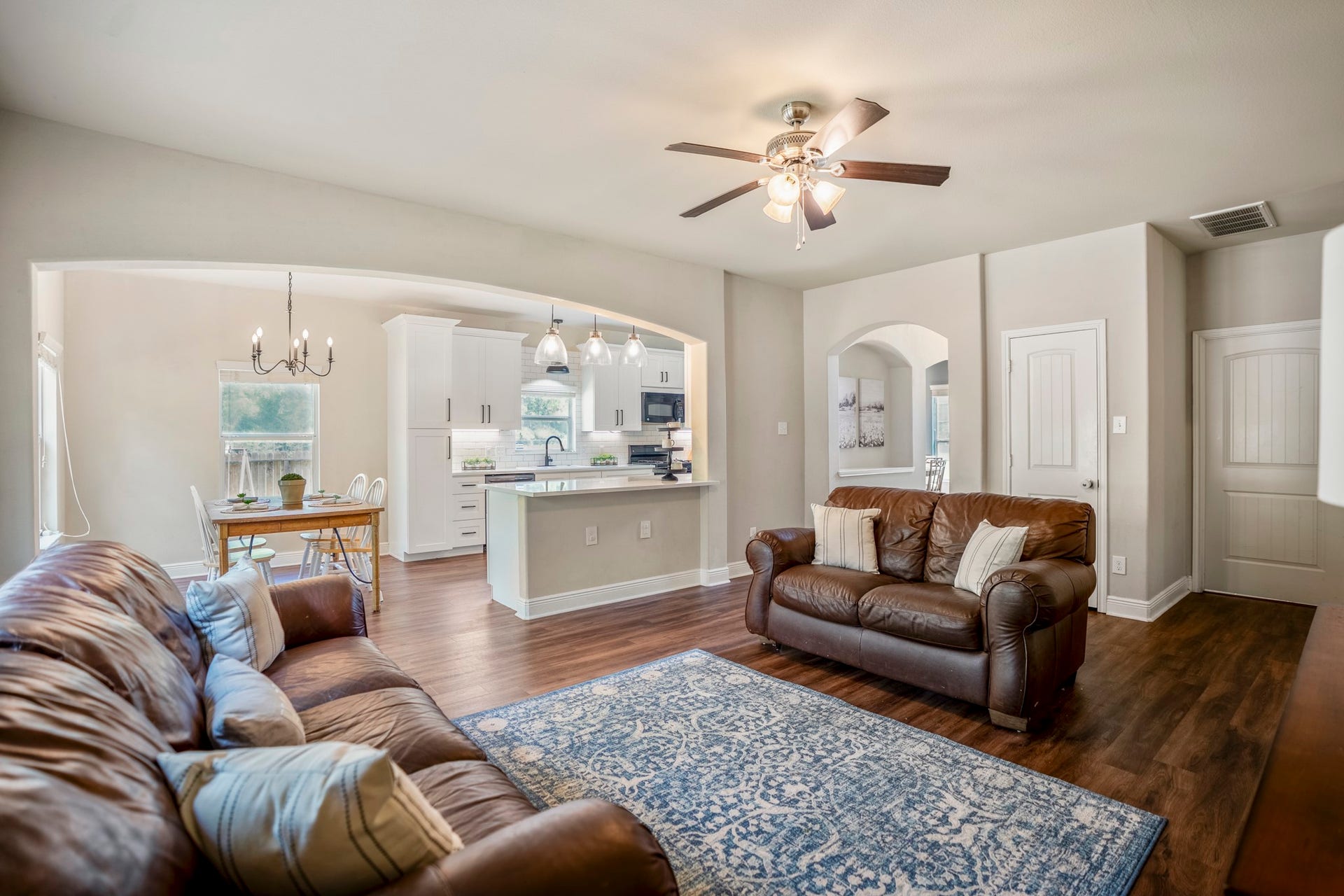 942 Oak Glen Drive, Conroe, TX 77378 Looking back across the living room, you can see how closely it connects to the kitchen and breakfast area beyond. The room still has plenty of definition for a full seating arrangement, while the open connection keeps conversation moving easily between the main gathering spaces.