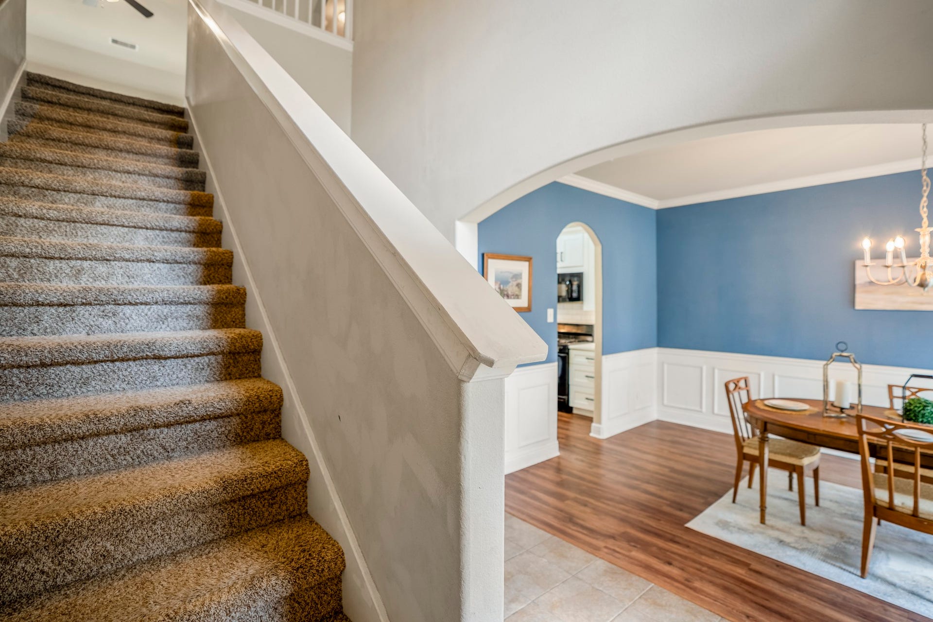 942 Oak Glen Drive, Conroe, TX 77378 As you head upstairs, the open stairwell gives you a glimpse of the second floor above while keeping the formal dining room in view below. Its a nice visual connection between the two levels, with the blue-and-white dining room adding a pop of personality before the staircase leads you toward the gameroom and secondary bedrooms.