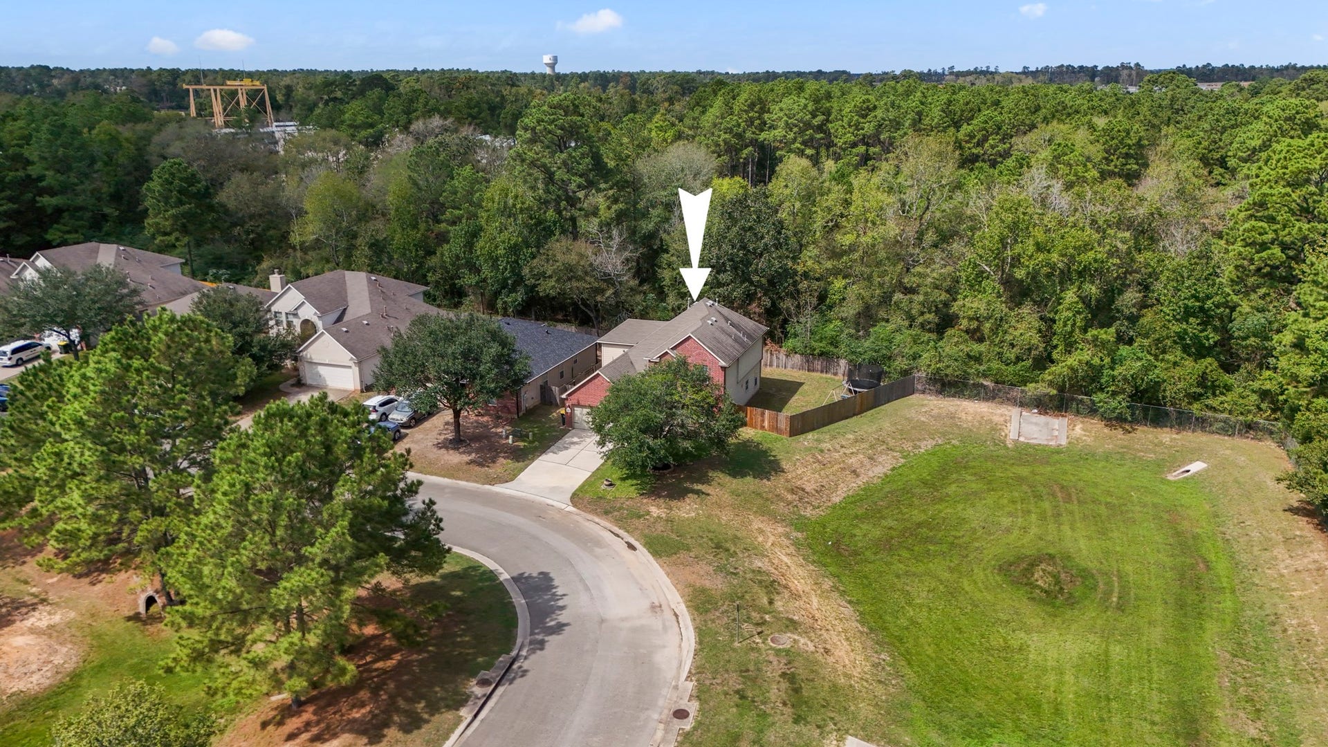 942 Oak Glen Drive, Conroe, TX 77378 From above, you can really see what makes this homesite differentno back neighbor, no neighbor on the right side, and no home directly across the street. That extra breathing room gives the property a more open feel from every angle, with mature trees and green space surrounding much of the view.