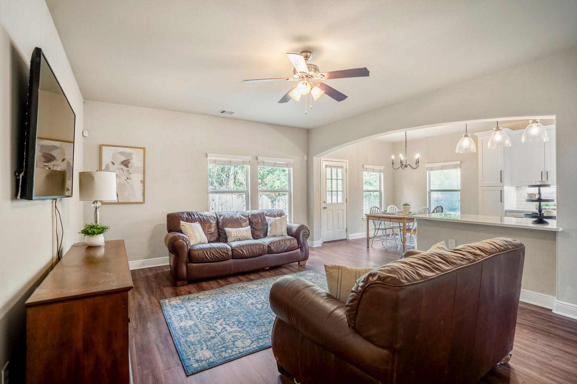 942 Oak Glen Drive, Conroe, TX 77378 Moving into the living room, windows along the back and side bring in plenty of natural light and views toward the yard. Theres room to settle in for movie nights, slower weekends, or everyday downtime while still staying connected to the rest of the downstairs.