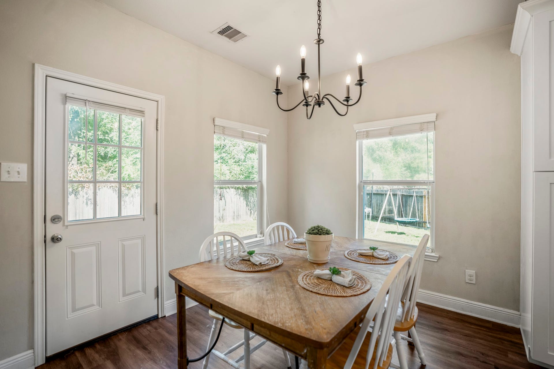 942 Oak Glen Drive, Conroe, TX 77378 Finishing this section in the breakfast area, windows bring in natural light while the back door keeps the yard only a few steps away. Its an easy spot for morning coffee, casual dinners, or lingering at the table before heading outside.
