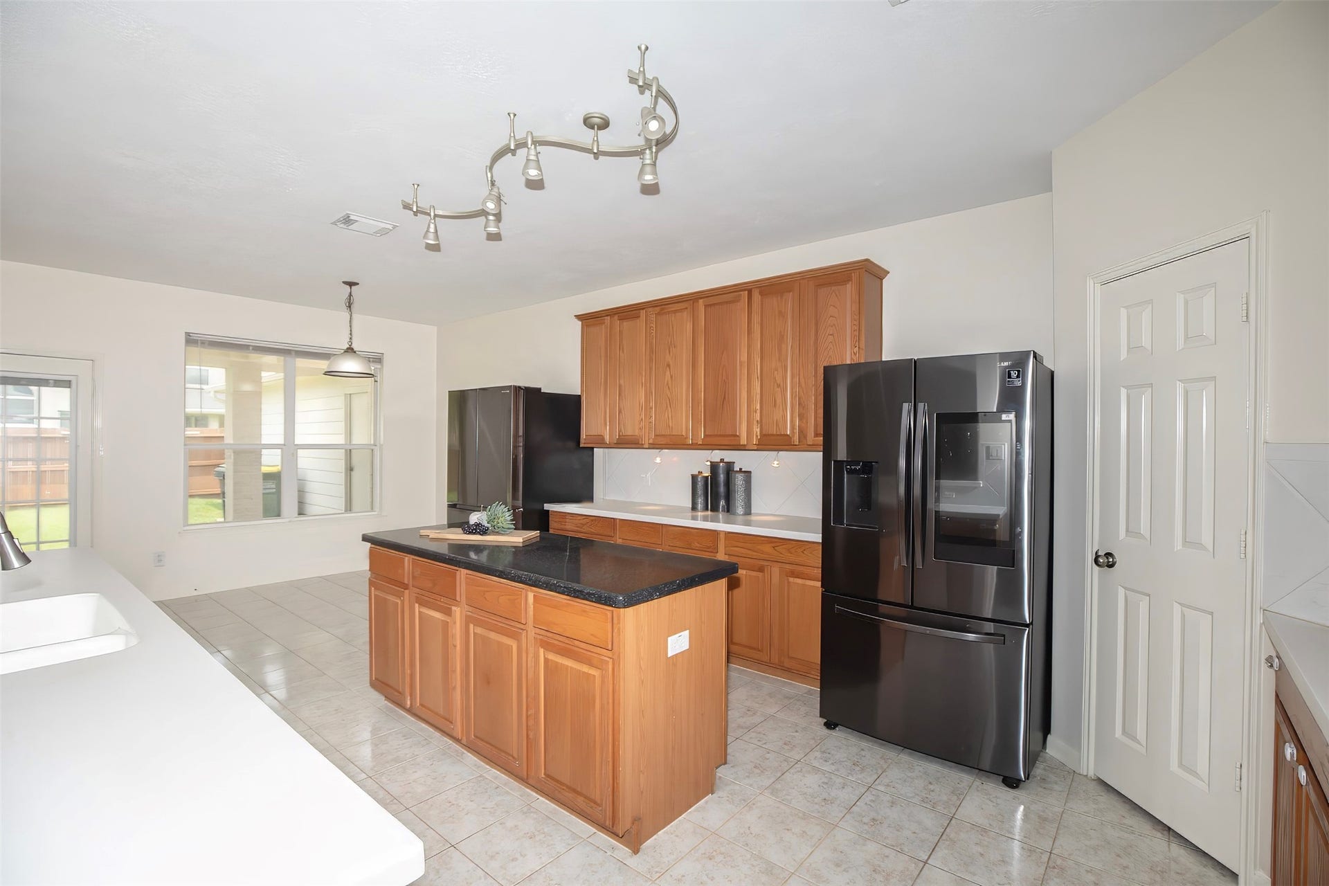 3612 Fir Hollow Way, Pearland, TX 77581 The spacious kitchen offers abundant cabinetry, generous counter space, and a large center island perfectly positioned for meal prep and gathering.