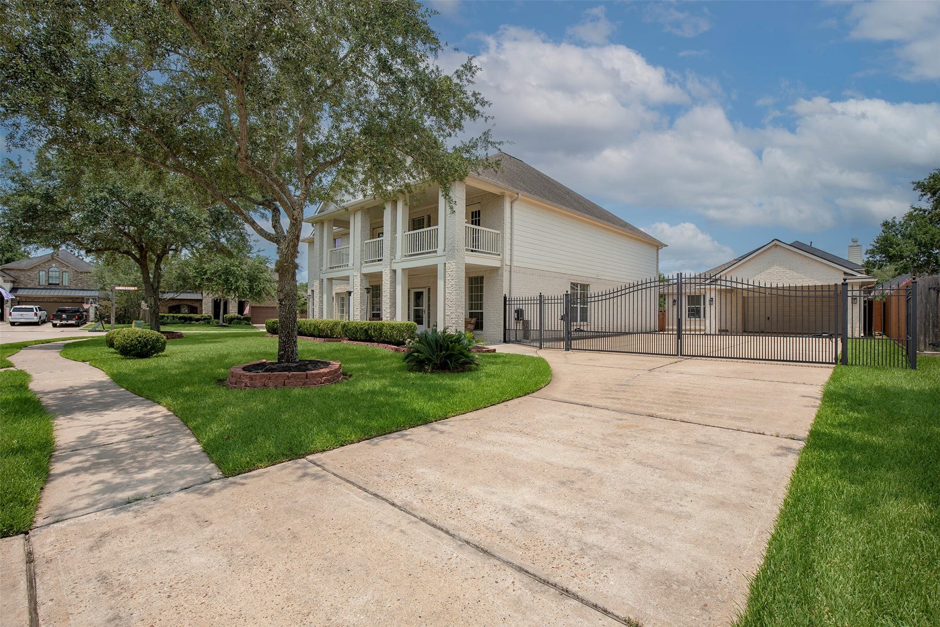 3612 Fir Hollow Way, Pearland, TX 77581 Private gated driveway leads to the detached garage, providing additional parking, security, and flexibility.