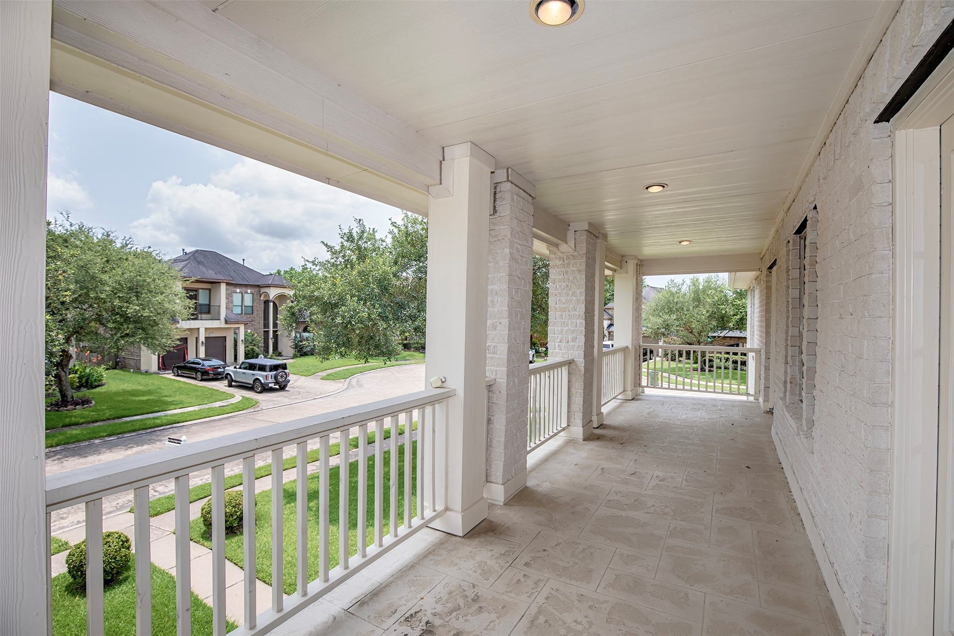 3612 Fir Hollow Way, Pearland, TX 77581 Stretching across the front of the home, this spacious covered balcony creates the perfect setting for relaxing outdoors while overlooking the quiet corner lot and beautifully maintained surroundings.