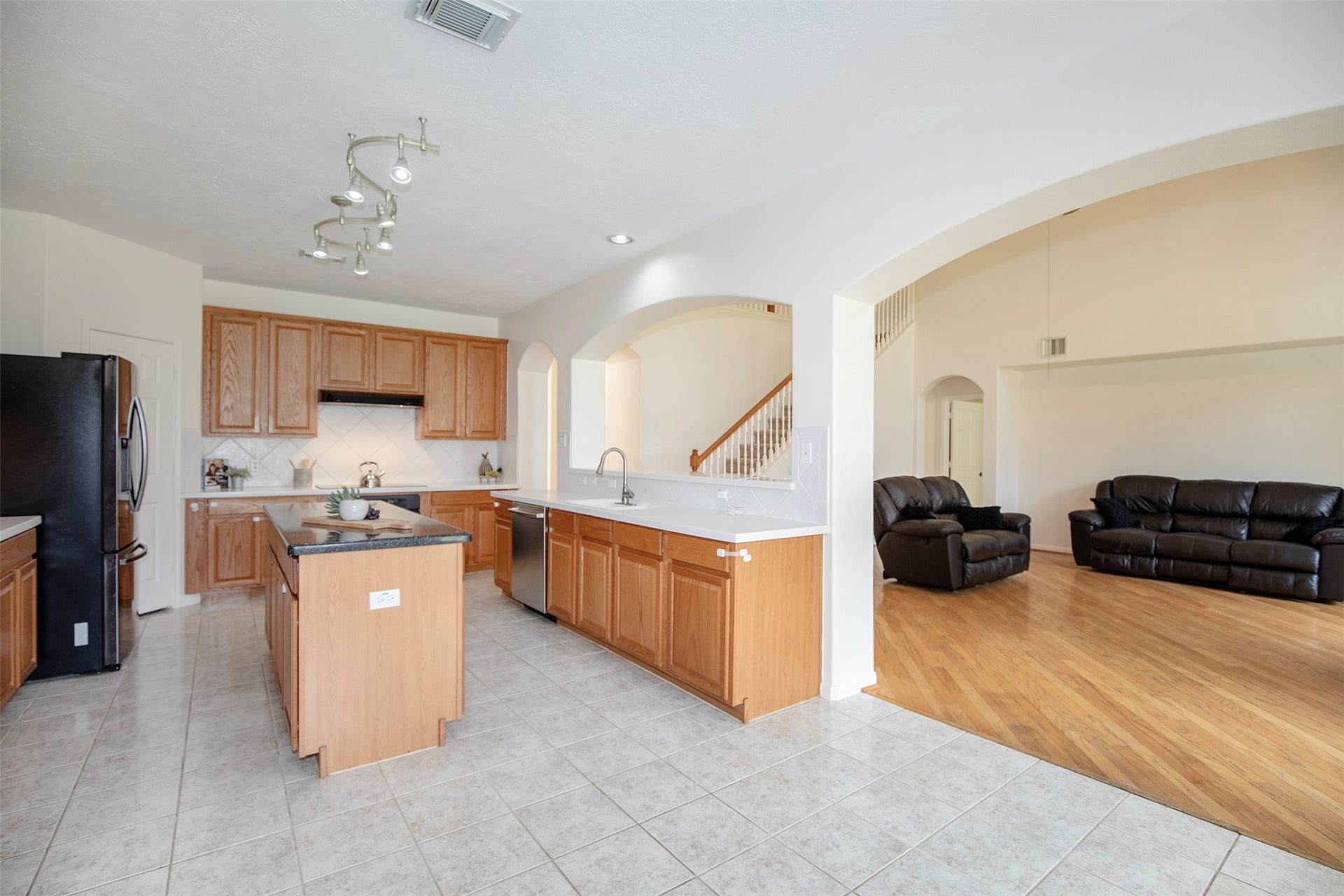 3612 Fir Hollow Way, Pearland, TX 77581 The seamless connection between the family room, breakfast area, and kitchen creates an ideal layout for entertaining and everyday living.