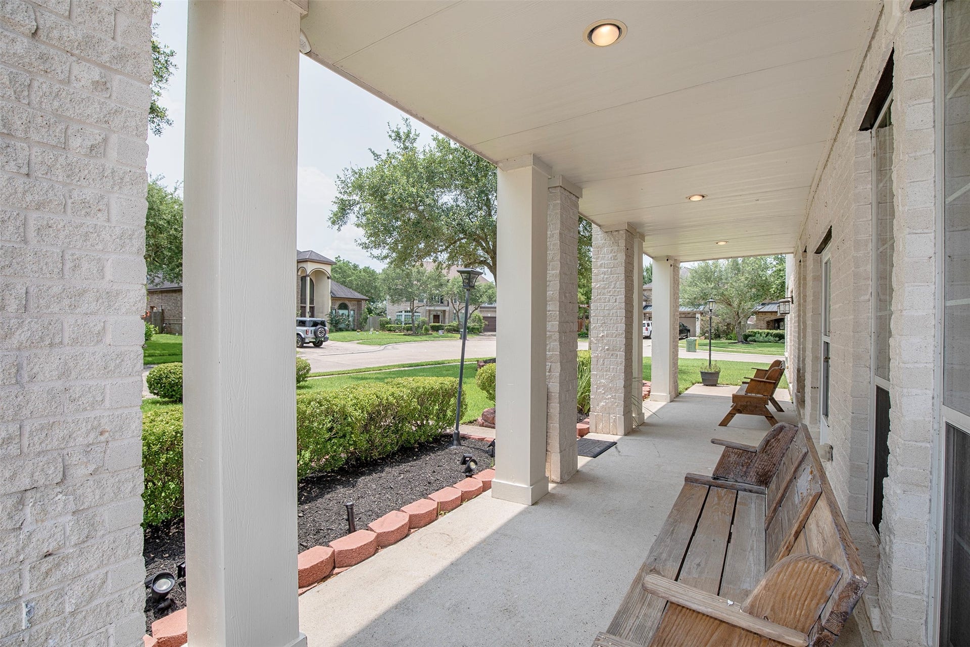 3612 Fir Hollow Way, Pearland, TX 77581 Expansive covered front porch provides the perfect place to enjoy morning coffee or relax while taking in the peaceful neighborhood setting.