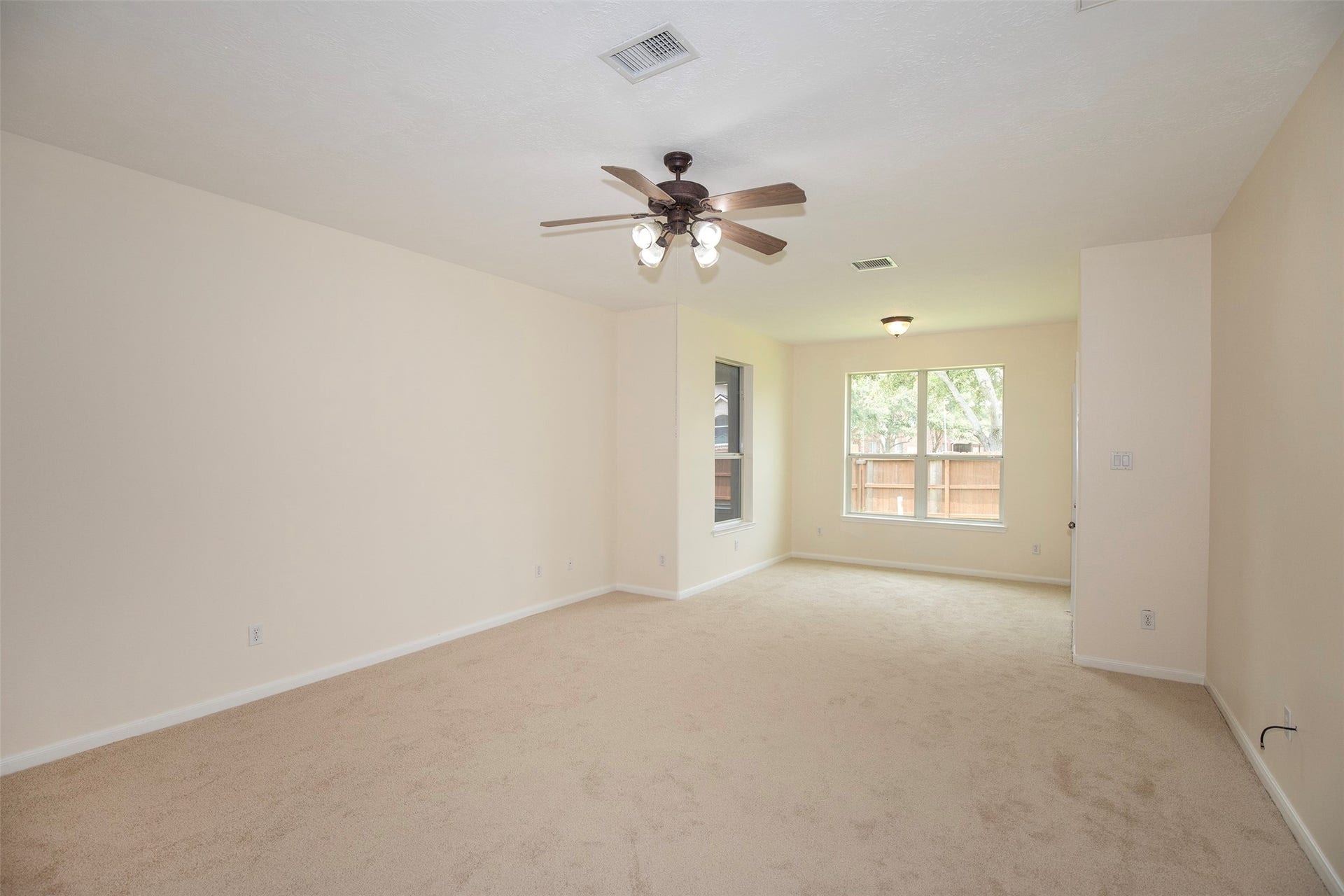 3612 Fir Hollow Way, Pearland, TX 77581 Generously sized primary retreat offers room for a sitting area and overlooks the backyard through large windows that fill the space with natural light.