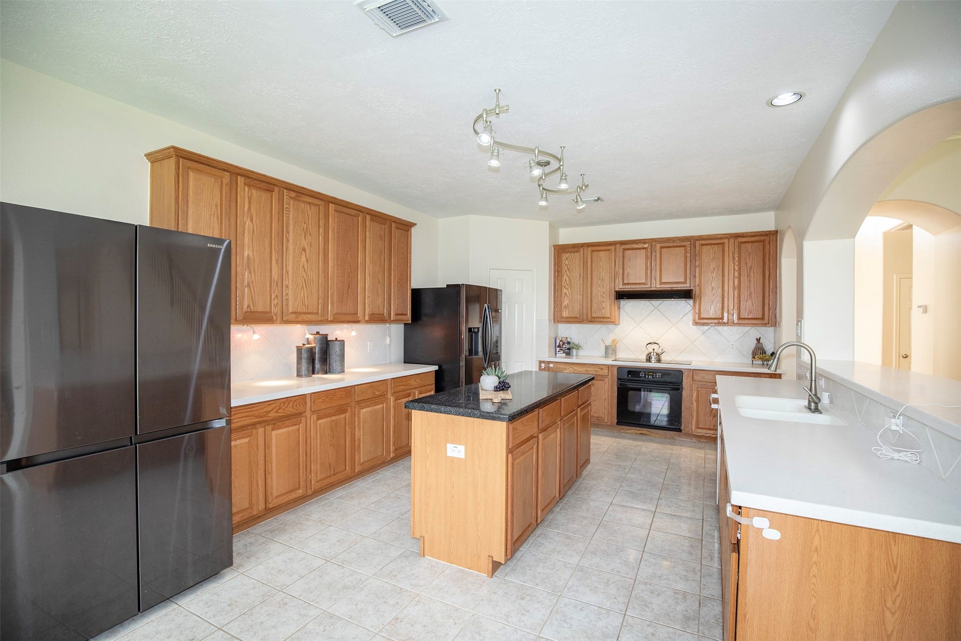 3612 Fir Hollow Way, Pearland, TX 77581 Grand kitchen with oversized island, abundant cabinetry, and seamless flow to the living areas.