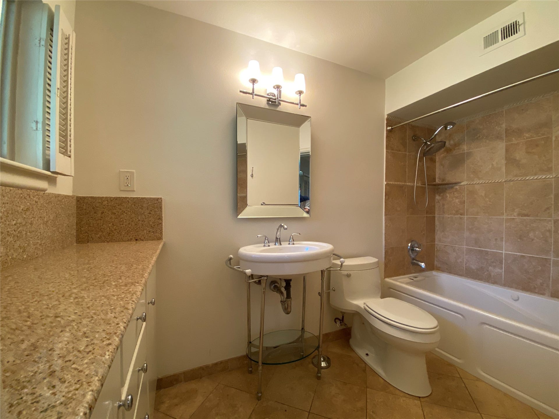 3207 Banbury Place, Houston, TX 77027 The primary bath with tub/shower combo and counter top with lots of drawer/cabinet storage below.