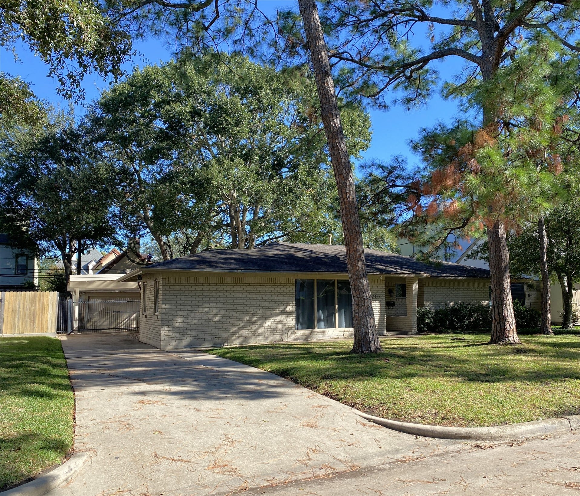 3207 Banbury Place, Houston, TX 77027 The long driveway leads to a gated carport and garage.