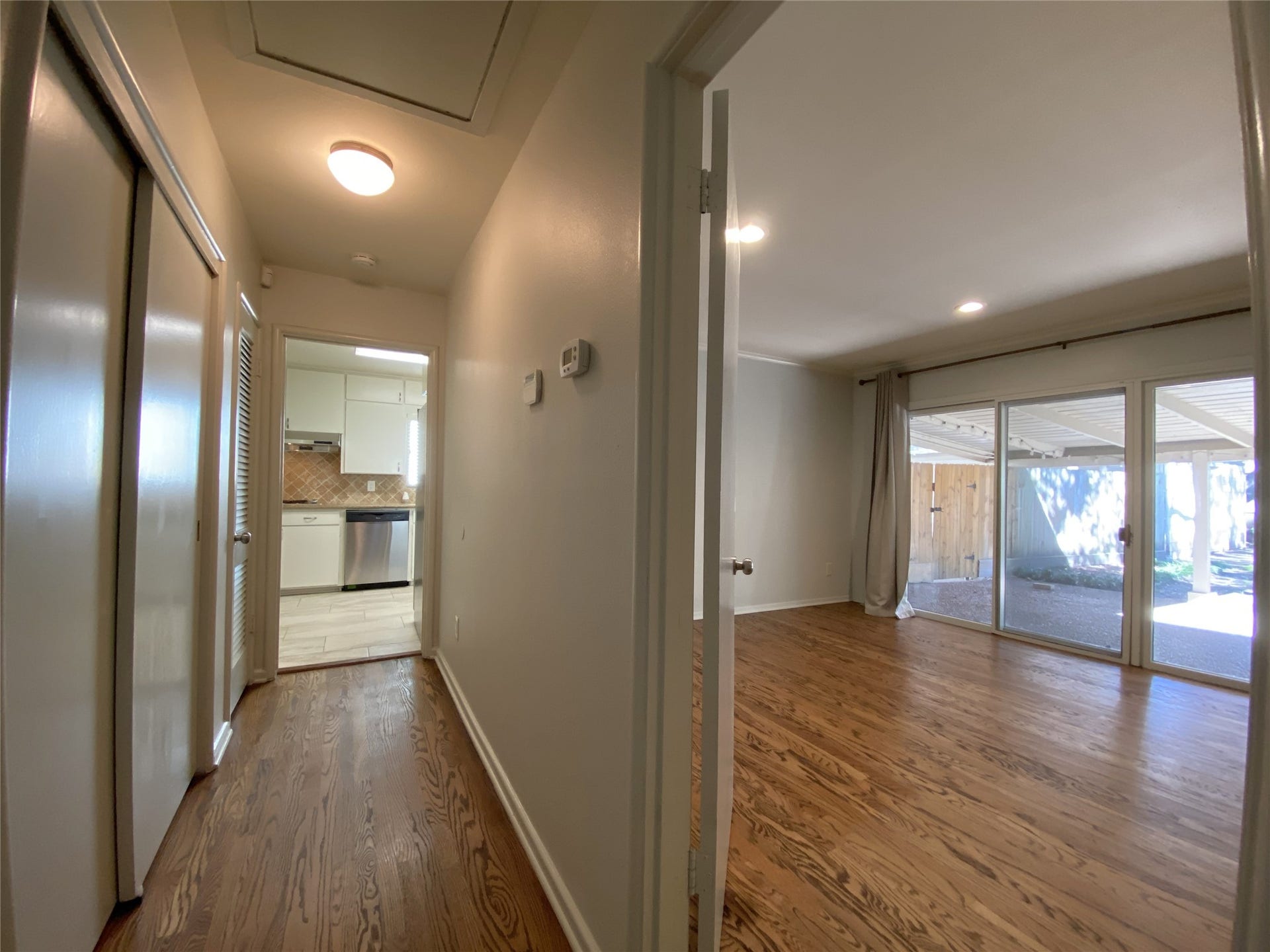 3207 Banbury Place, Houston, TX 77027 Pictured on the right , is the first secondary bedroom with a sliding door opening to the covered section of the patio. The closet in this bedroom has been converted into a built-in desk which makes it perfect for a home office. In the hallway, behind the sliding door on the left and immediately near to the bedroom door, is a nicely sized closet for clothing.