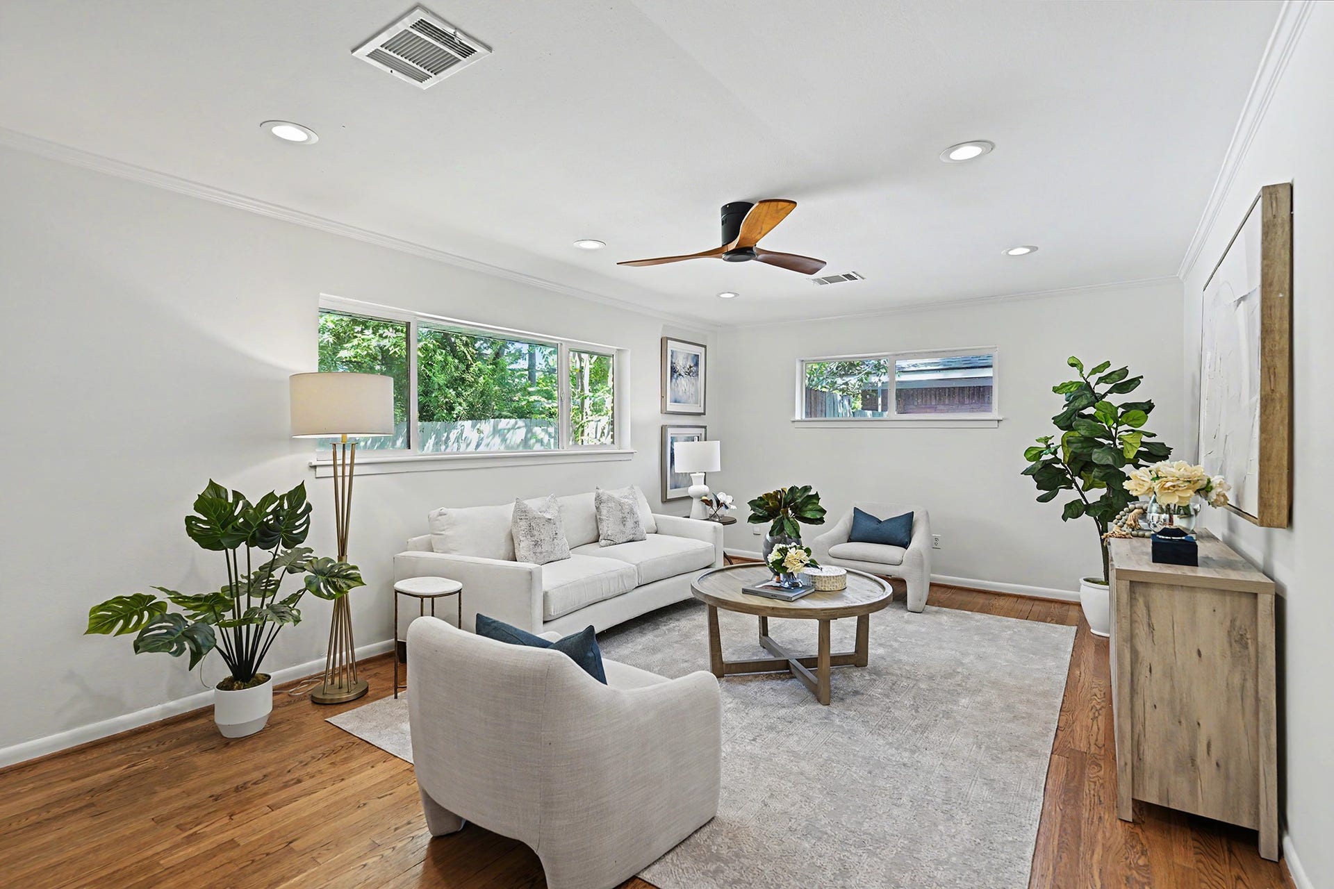 Spacious living room with hardwood floors and great natural light