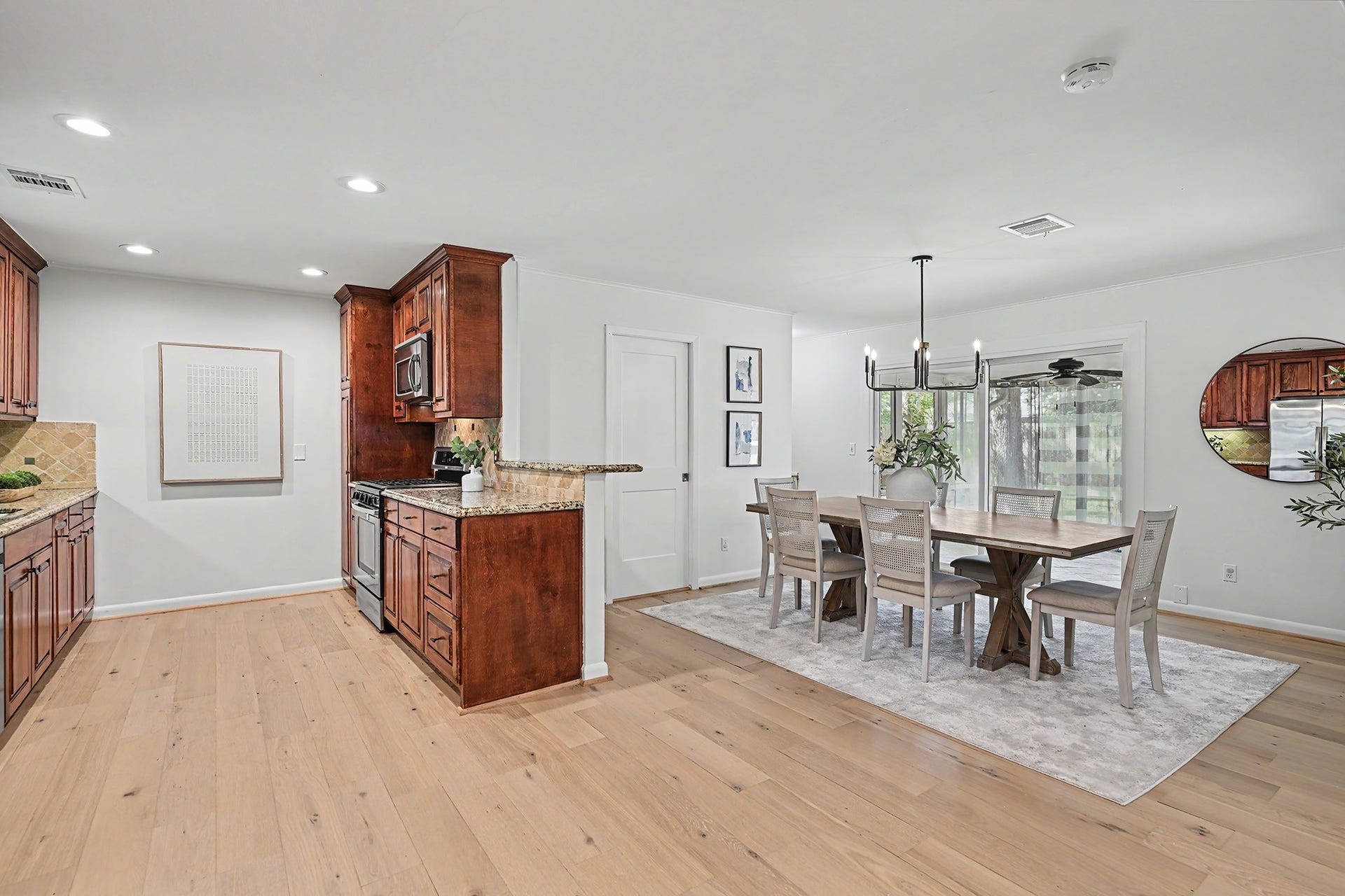 Large, open kitchen and dining with engineered wood floor