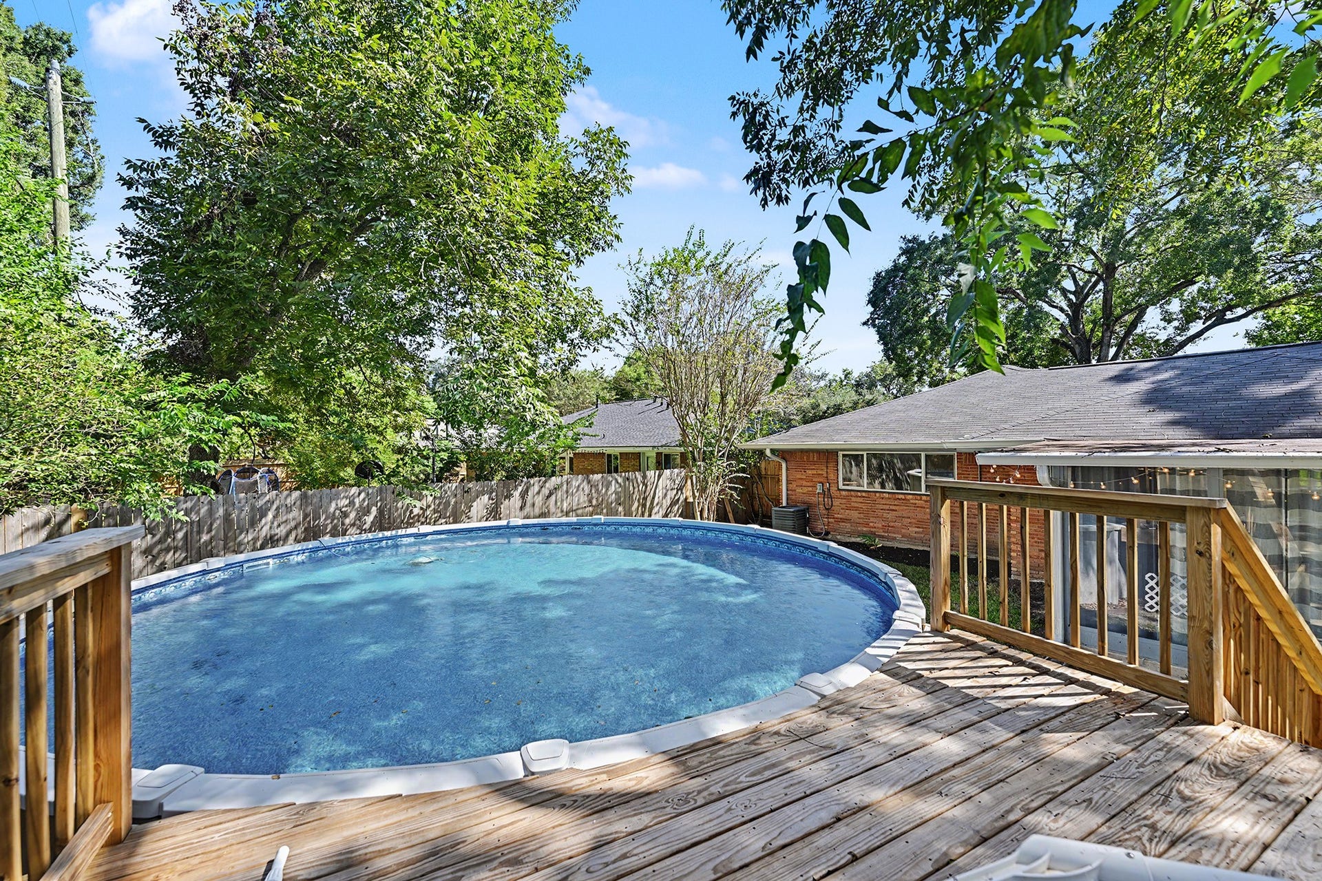 Enjoy your backyard making summer memories with this above-ground saltwater pool with raised wooden deck