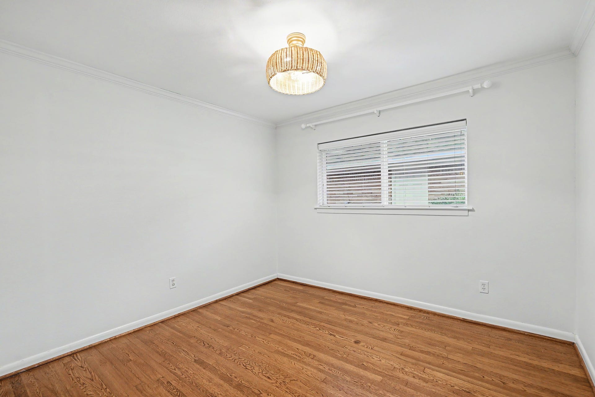 Secondary bedroom with hardwood floor