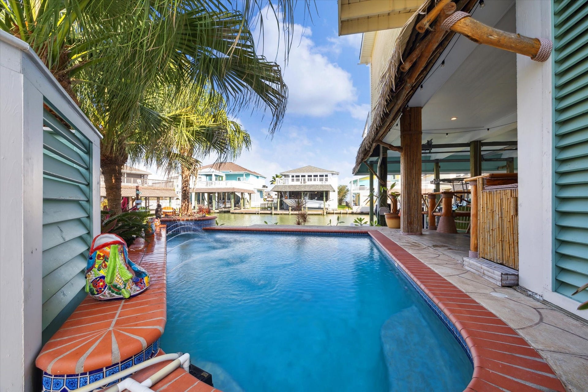 102 Bamaku Bend, Tiki Island, TX 77554 What a view! Water features in the pool add to the ambiance.