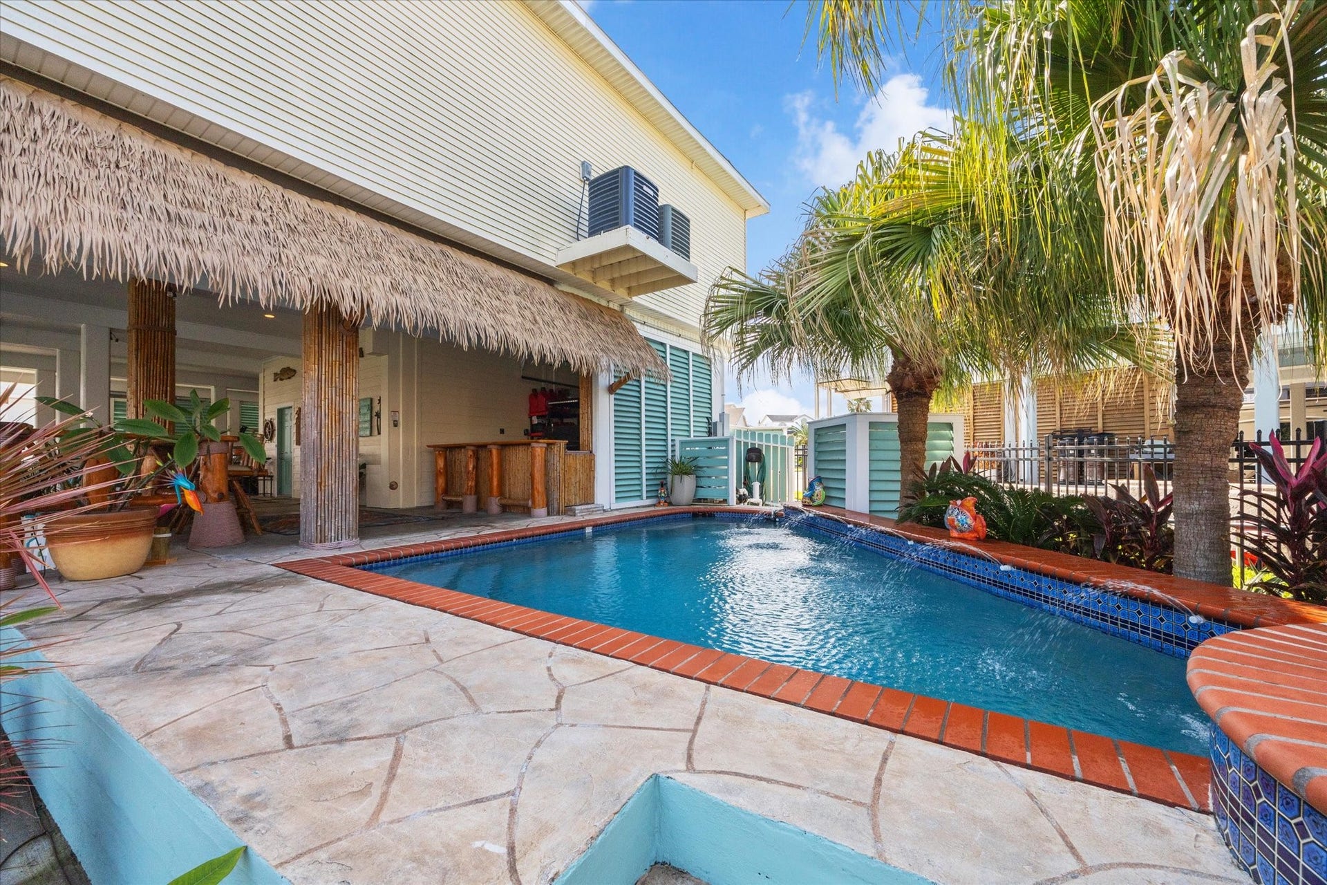 102 Bamaku Bend, Tiki Island, TX 77554 This outdoor space is hard to beat! The heated pool next to the palapa and tiki bar is just one of the spaces to enjoy outside at 102 Bamaku Bend.