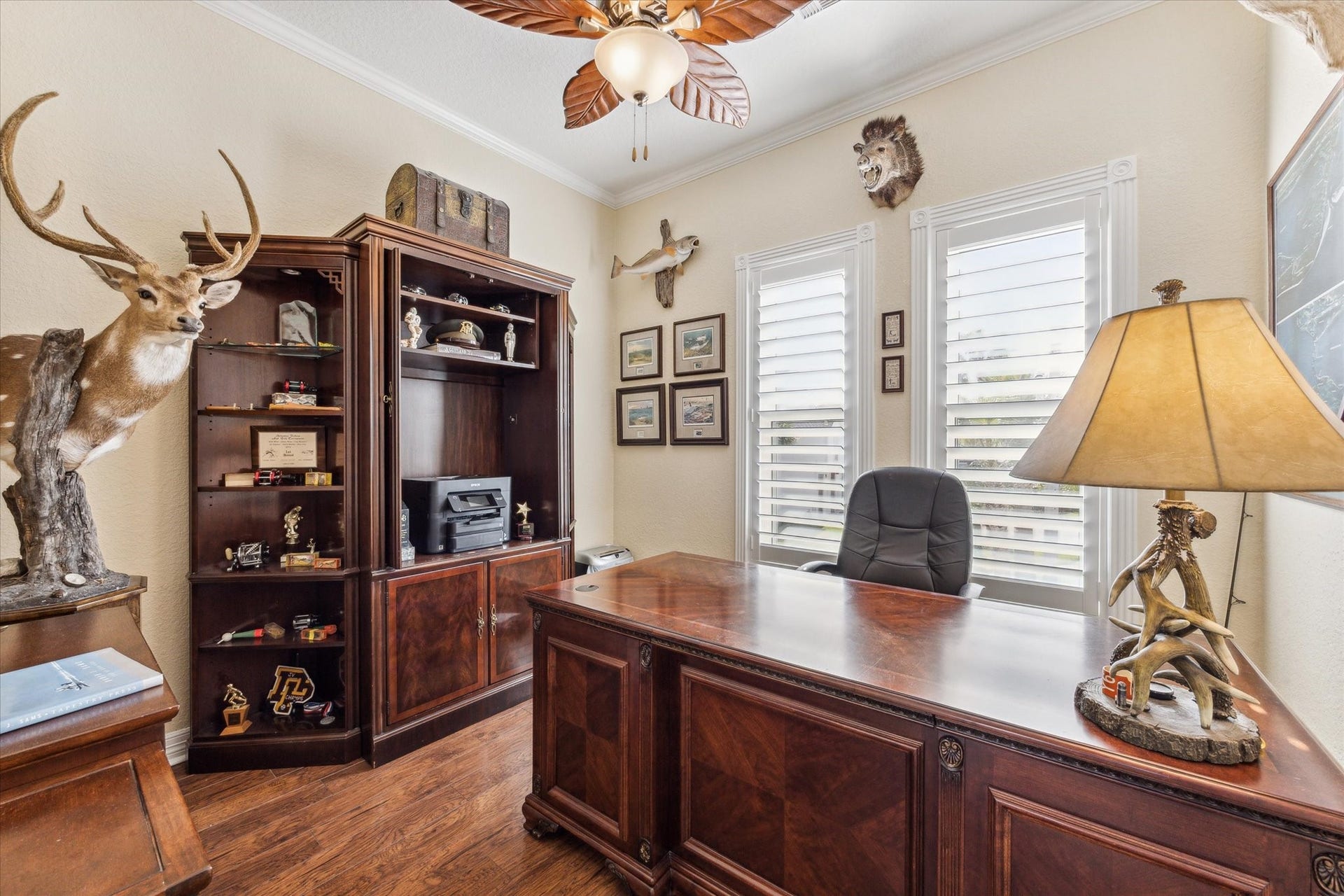 102 Bamaku Bend, Tiki Island, TX 77554 Tucked away in the corner of the home just off of the kitchen, dining and living areas is this room that makes the perfect home office or bedroom if needed. Beautiful wood floors, crown molding and detailed trim around the windows elevate this room.