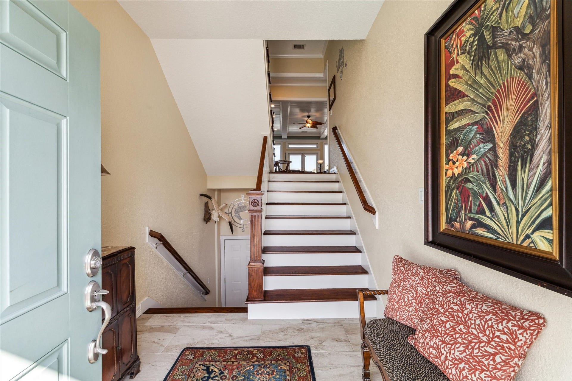 102 Bamaku Bend, Tiki Island, TX 77554 As you enter through the front door you will see that the foyer was extended 4 feet to enhance the beauty and space when you walk through the door. Downstairs you will find access to the garage, a storage closet under the stairs and a large storage room with access to the back of the home. As you go up the beautiful custom wood staircase you enter the grand living area.