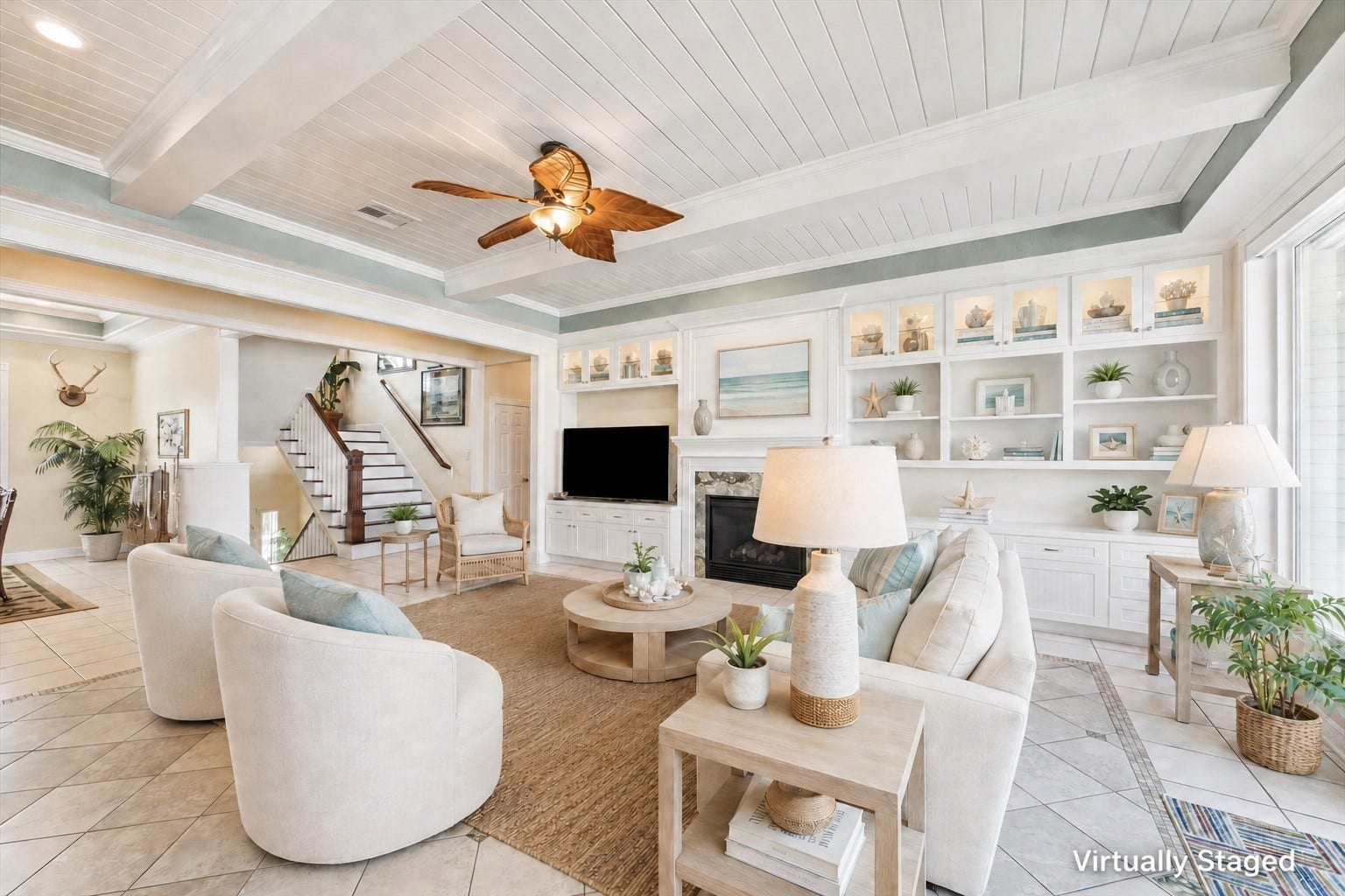 102 Bamaku Bend, Tiki Island, TX 77554 Another view of the living room virtually staged shows the beautiful gas log fireplace and custom cabinetry with ample storage. The open floor plan provides a view into the formal dining room to the left of the living room. Next to the dining room is the foyer and staircase going upstairs to the flex room and bathroom.
