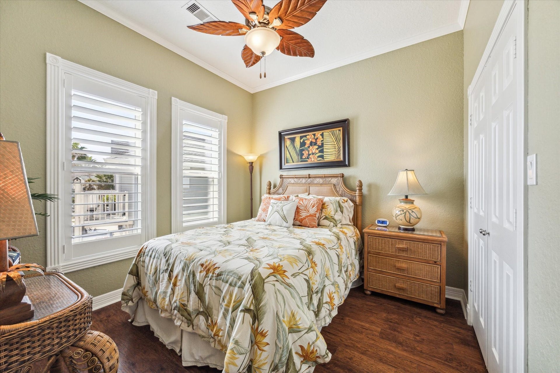 102 Bamaku Bend, Tiki Island, TX 77554 Wood floors continue through to this secondary bedroom which also has detailed trim around the windows, plantation shutters and a custom designed closet.