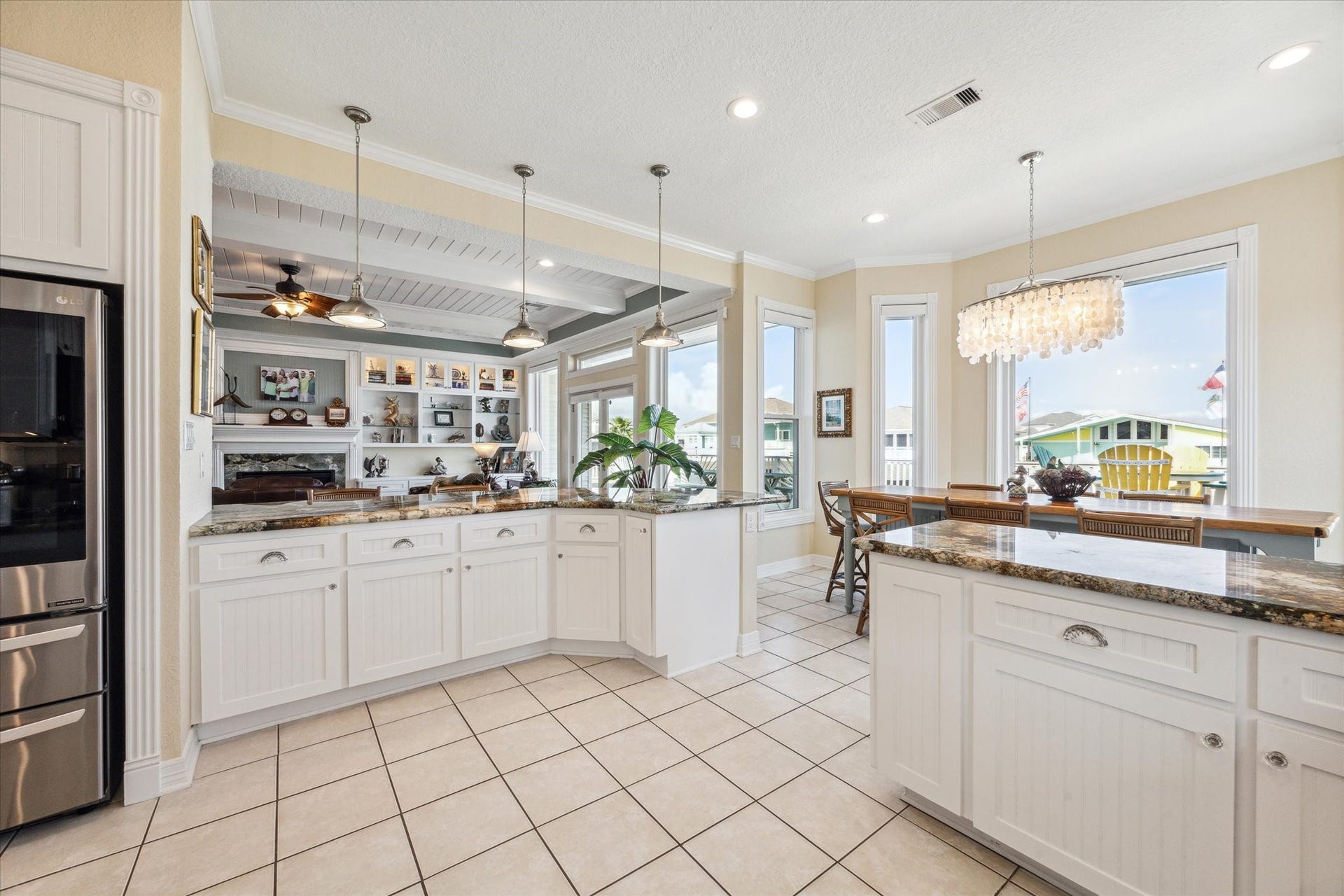 102 Bamaku Bend, Tiki Island, TX 77554 The seamless flow from the kitchen to the breakfast room and living room creates an ideal space for entertaining, allowing everyone to stay connected and be part of the conversation.
