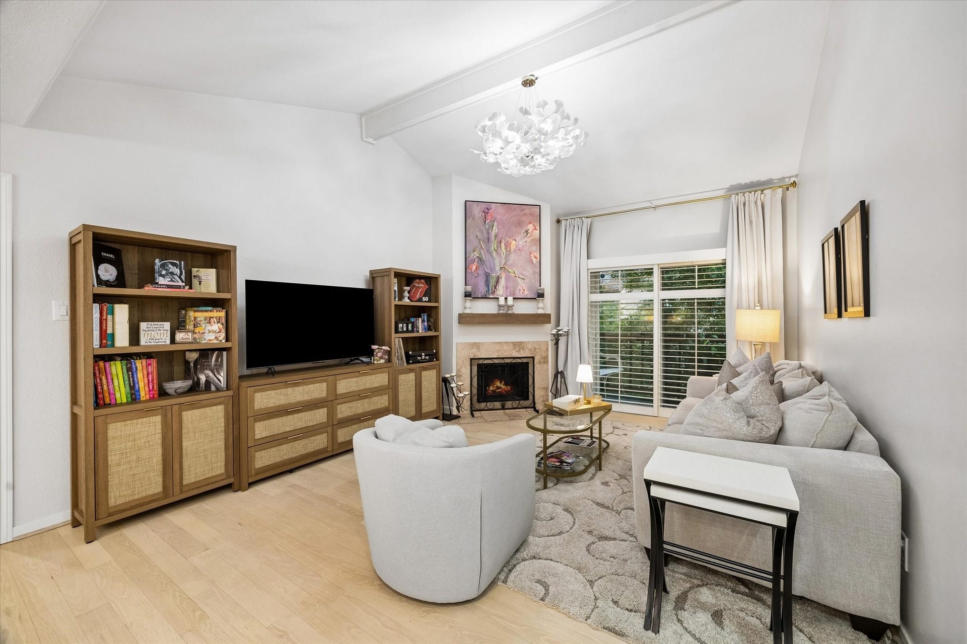 Living room with fireplace and view of balcony which is serene - feel like you are living in a tree house
