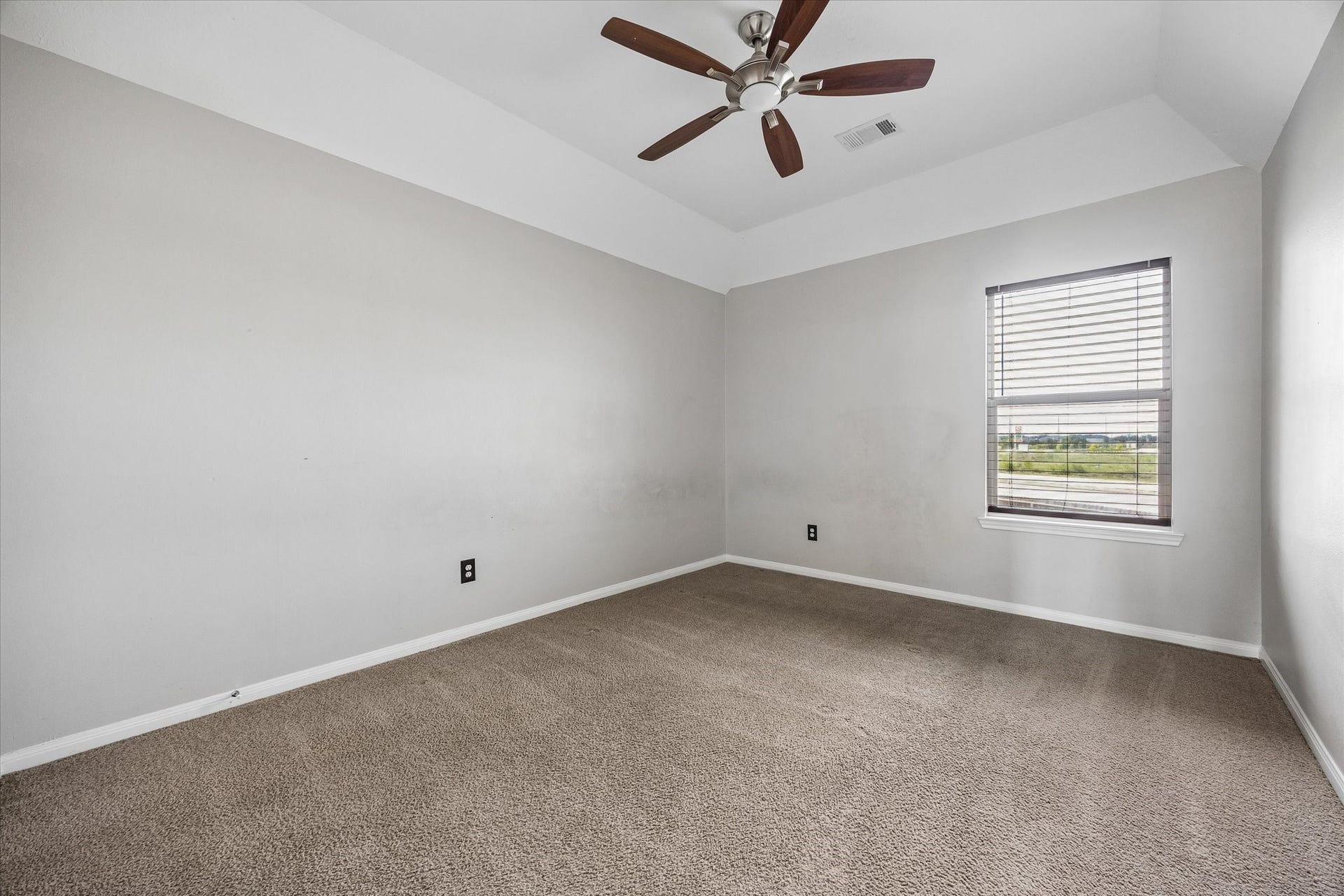 8422 W W Sienna Cove Lane Lane, Houston, TX 77083 Secondary Bedroom: Spacious upstairs bedroom featuring neutral carpeting, a ceiling fan, and natural light.