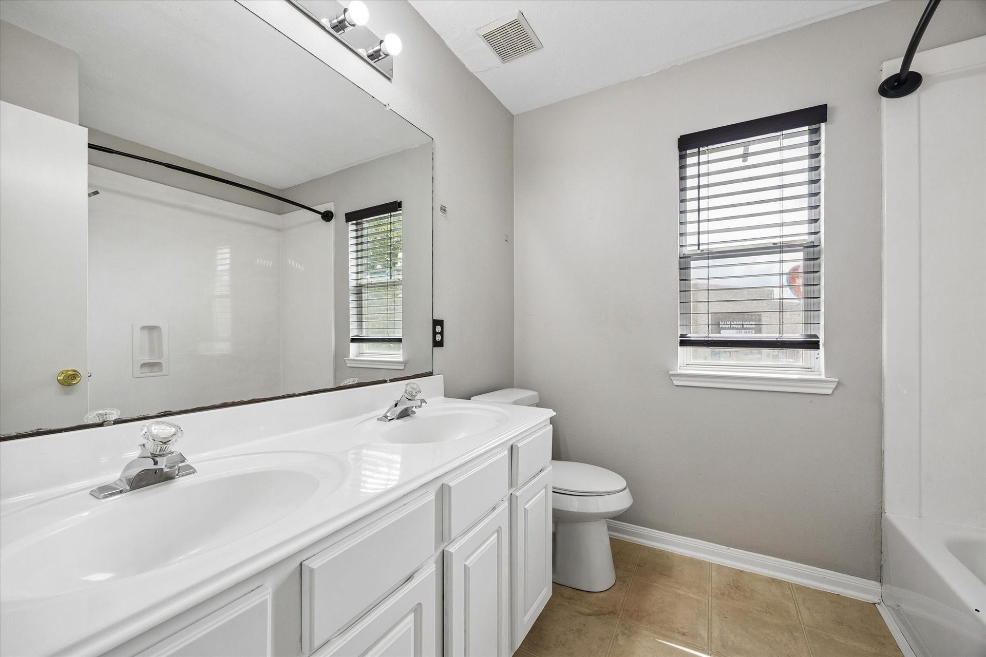8422 W W Sienna Cove Lane Lane, Houston, TX 77083 Upstairs Full Bathroom: Featuring an extended vanity with ample counter space, neutral finishes, and natural light.