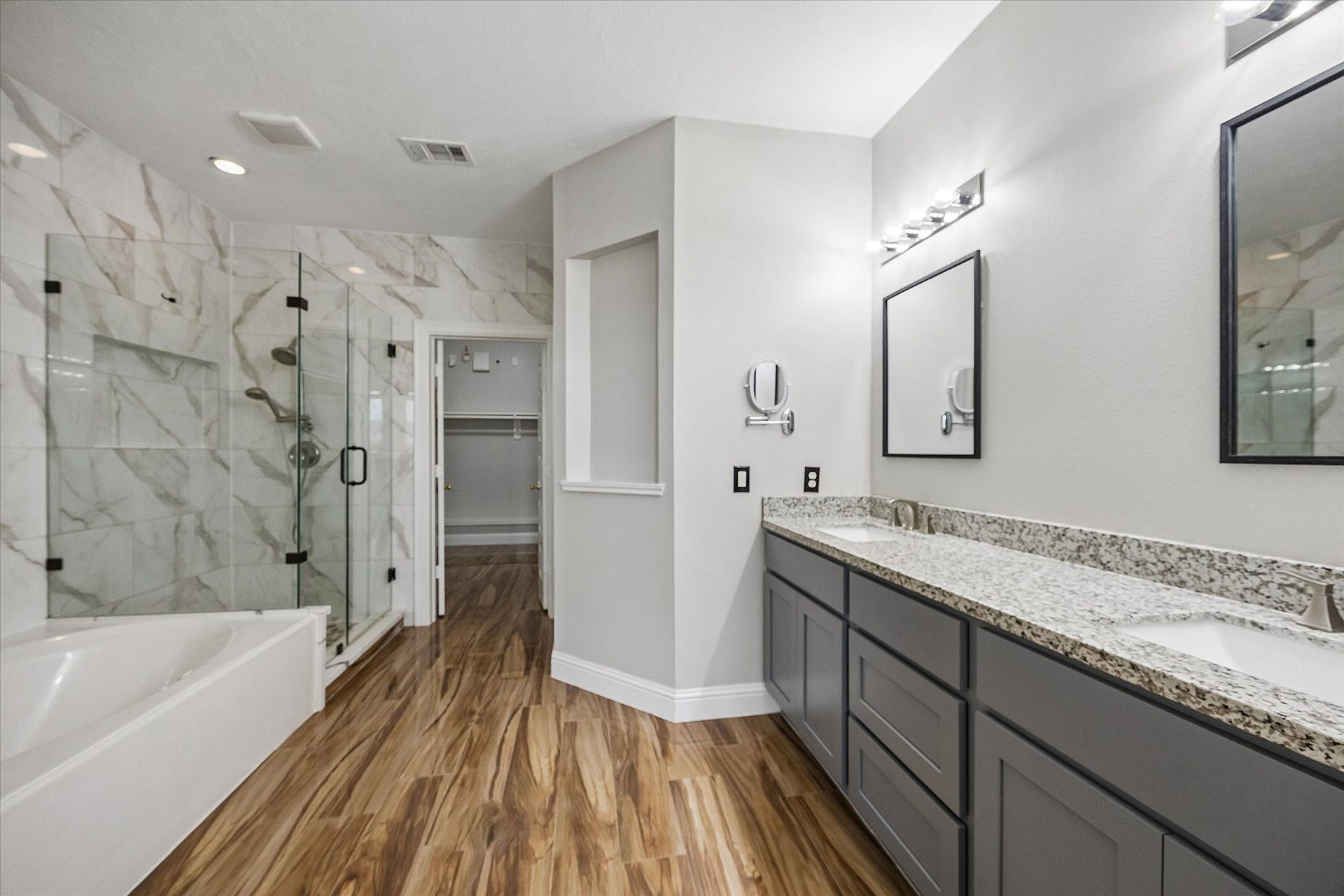 8422 W W Sienna Cove Lane Lane, Houston, TX 77083 Primary Bathroom: Beautifully updated ensuite featuring dual vanities, granite countertops, and a spacious walk-in shower with elegant tile finishes.