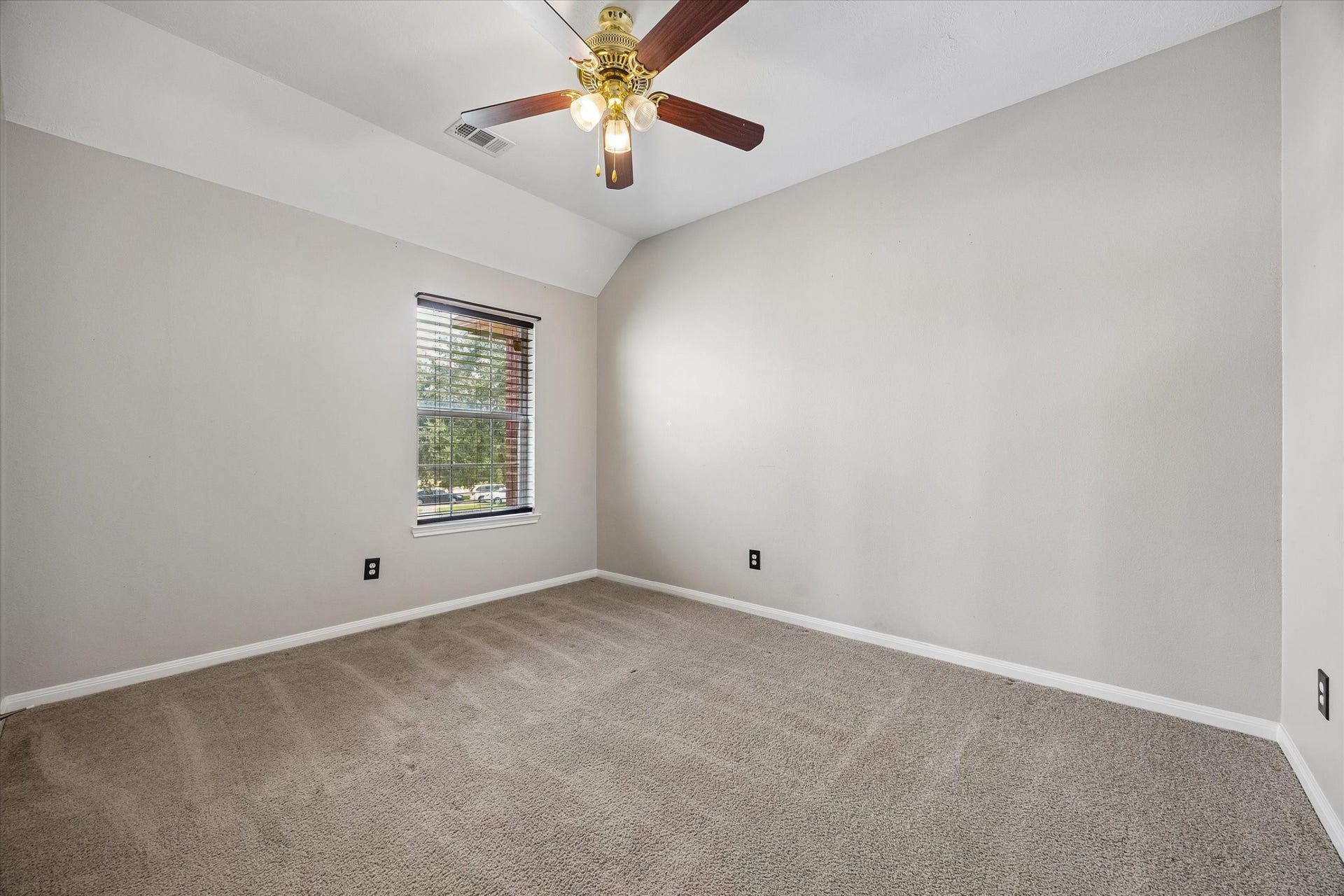 8422 W W Sienna Cove Lane Lane, Houston, TX 77083 Secondary Bedroom: Comfortable upstairs bedroom featuring neutral carpeting, a ceiling fan, and natural light.