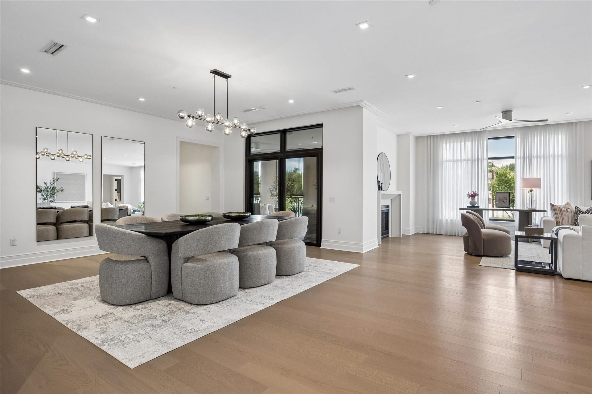 6017 Memorial, #202, Houston, TX 77007 This perspective captures the natural connection between the dining and living spaces, with floor-to-ceiling windows, a private terrace, and generous proportions creating a beautiful backdrop for both everyday living and memorable gatherings.
