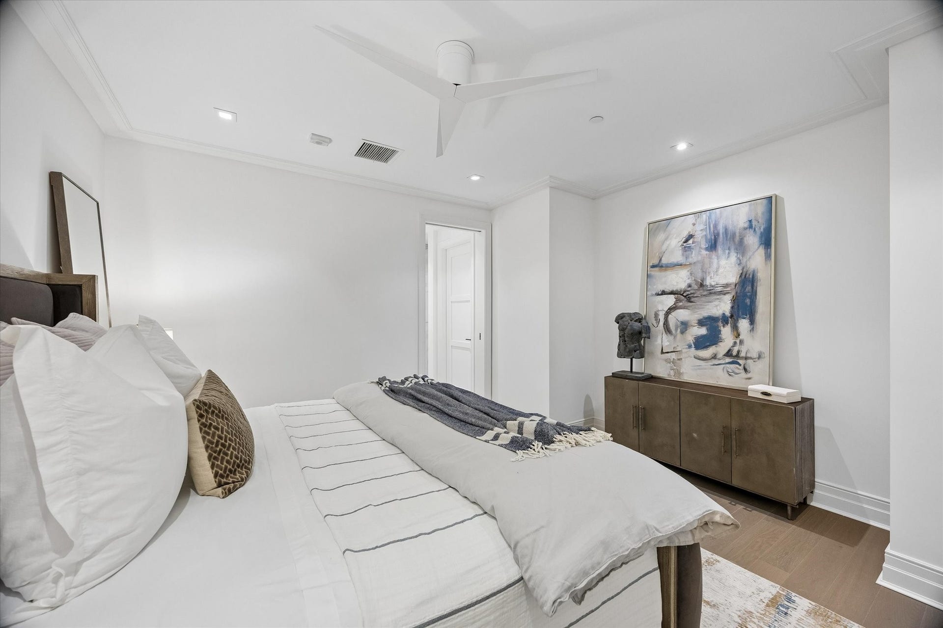 6017 Memorial, #202, Houston, TX 77007 The guest suite continues with thoughtful functionality, featuring a generous walk-in closet tastefully configured with custom storage by Space Manager.