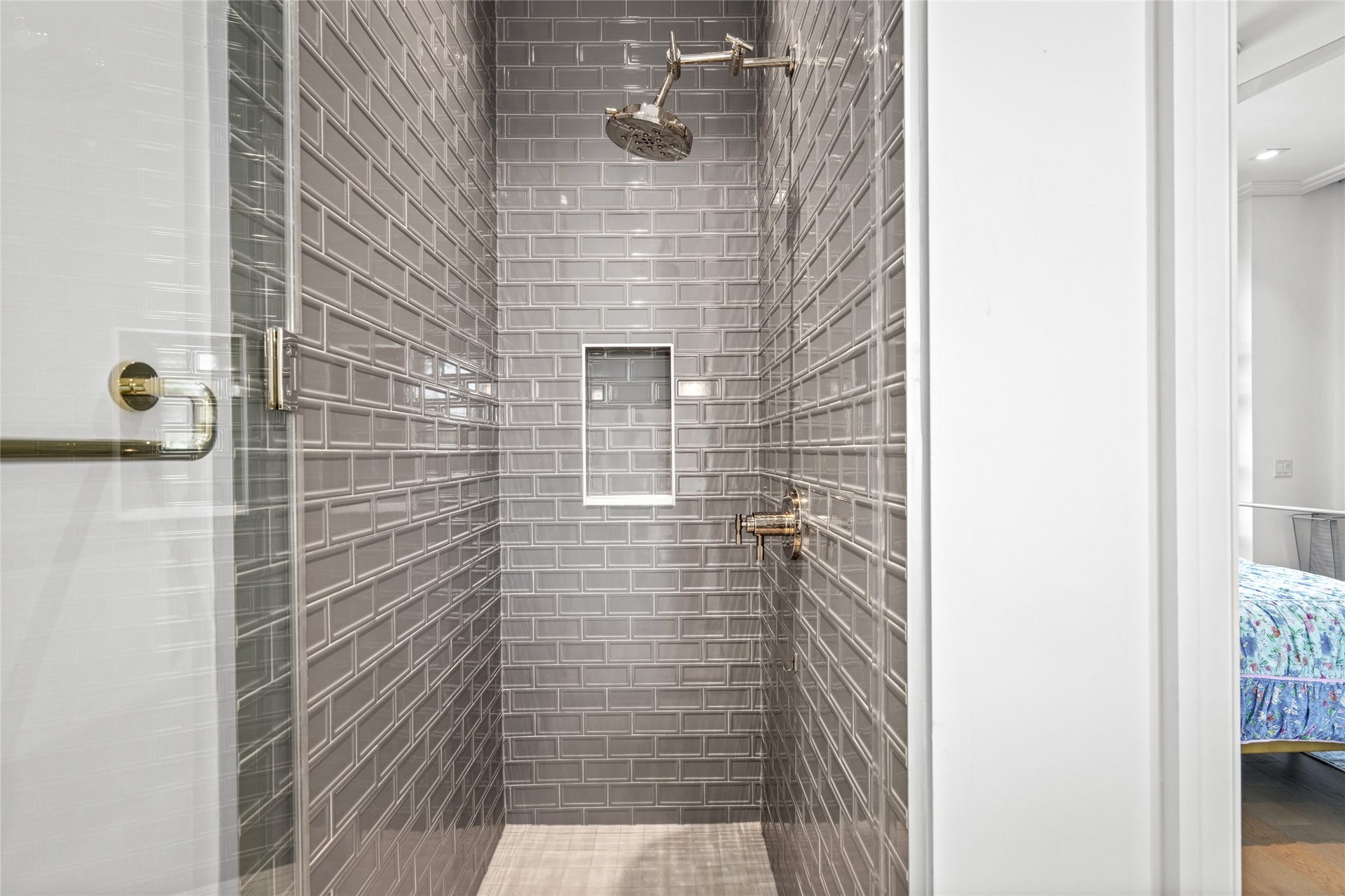 6017 Memorial, #202, Houston, TX 77007 Step into a stylish stand-up shower, finished with charcoal gray subway tiles and chrome fixtures.