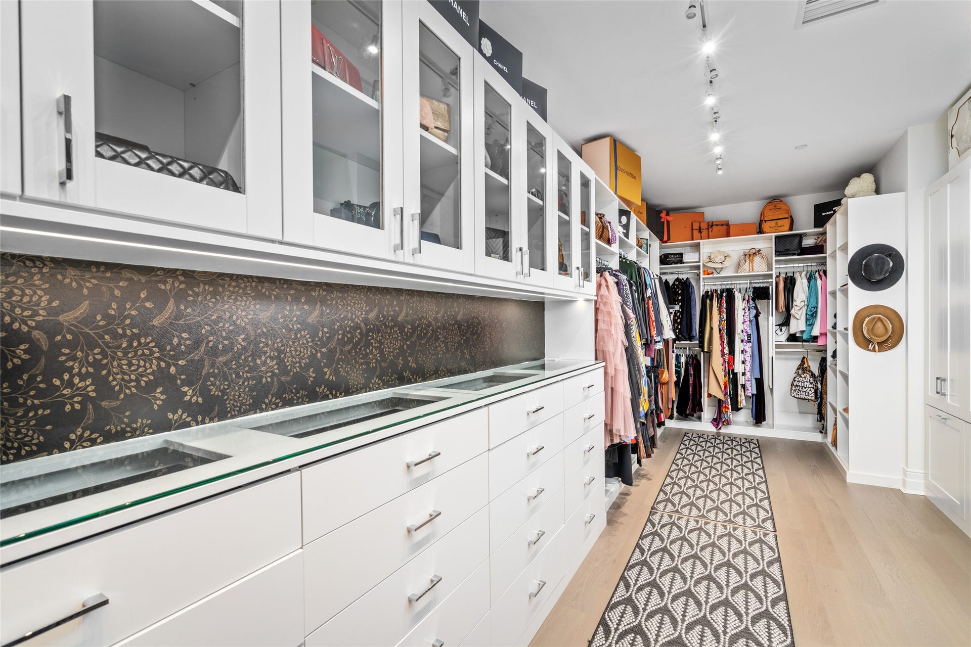 6017 Memorial, #202, Houston, TX 77007 The closet which is outfitted by Space Manager features glass front cabinets, glass top display cases with jewelry
compartments, built in shelves and drawers, and an unbelievable amount of hanging space.