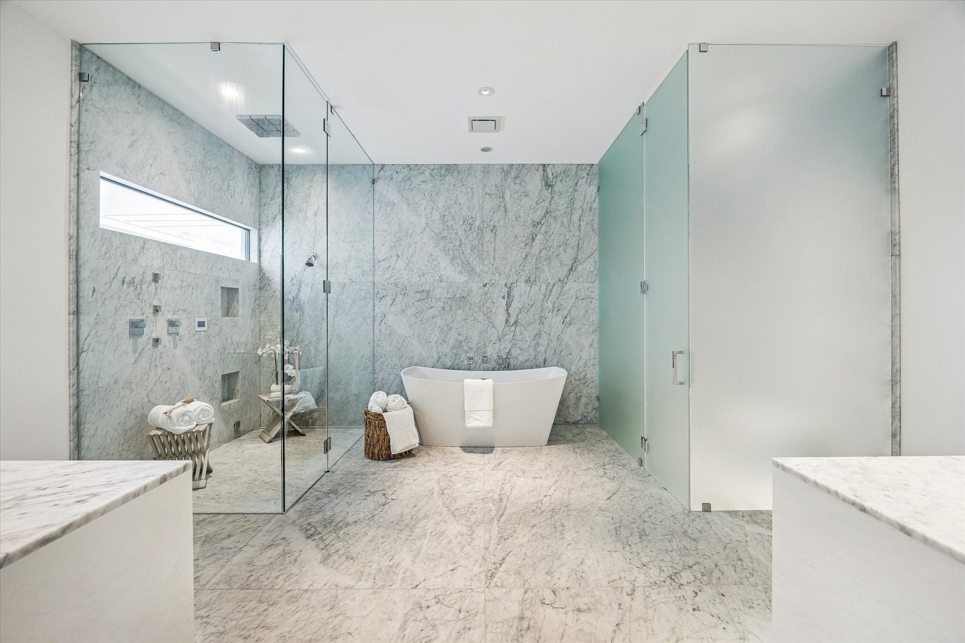 1527 Indiana Street, Houston, TX 77006 Primary bath - featuring a commercial grade steam shower with an infinity drain and a wall of frameless glass and the freestanding tub takes center stage. The toilet and bidet will be enclosed with floor to ceiling privacy glass.