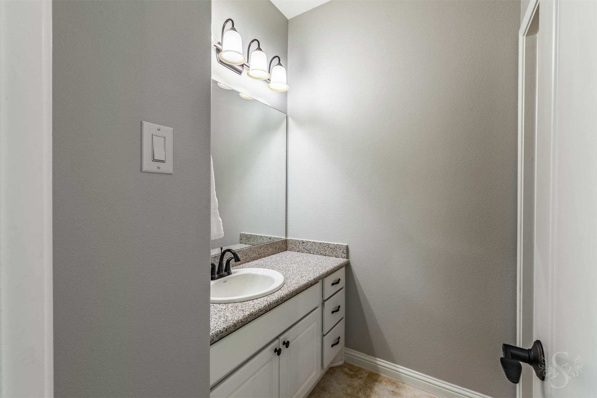 27506 Lakeway Trail Lane, Fulshear, TX 77441 A granite-topped vanity with crisp white cabinetry offers generous counter space for daily routines.