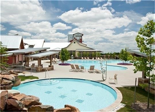 27506 Lakeway Trail Lane, Fulshear, TX 77441 Dive into resort-style living at Cross Creek Ranch! This is just one of three sparkling pools residents enjoy, complete with a splash pad and scenic lake views. Whether youre cheering on the neighborhood swim team or relaxing poolside under the Texas sun, every day feels like a getaway. Dont miss the iconic Lookout Tower in the distanceanother hallmark of this vibrant community.