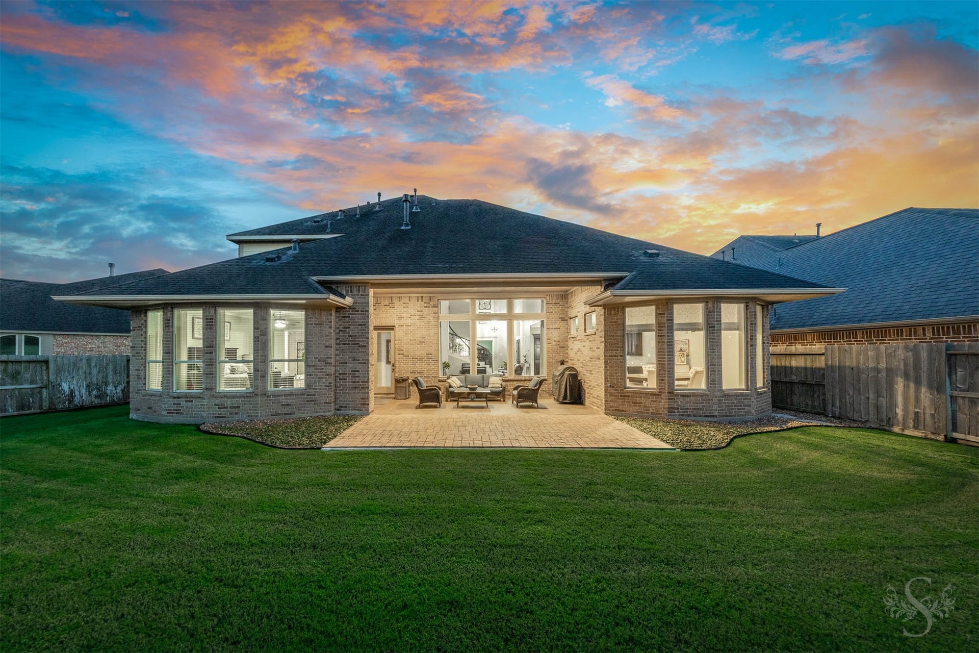 27506 Lakeway Trail Lane, Fulshear, TX 77441 The homes impressive rear elevation pairs graceful bay windows with a covered outdoor retreat overlooking the backyard. Gather beneath the patios shelter or enjoy dinner on the extended paver terrace, with plenty of green space beyond.