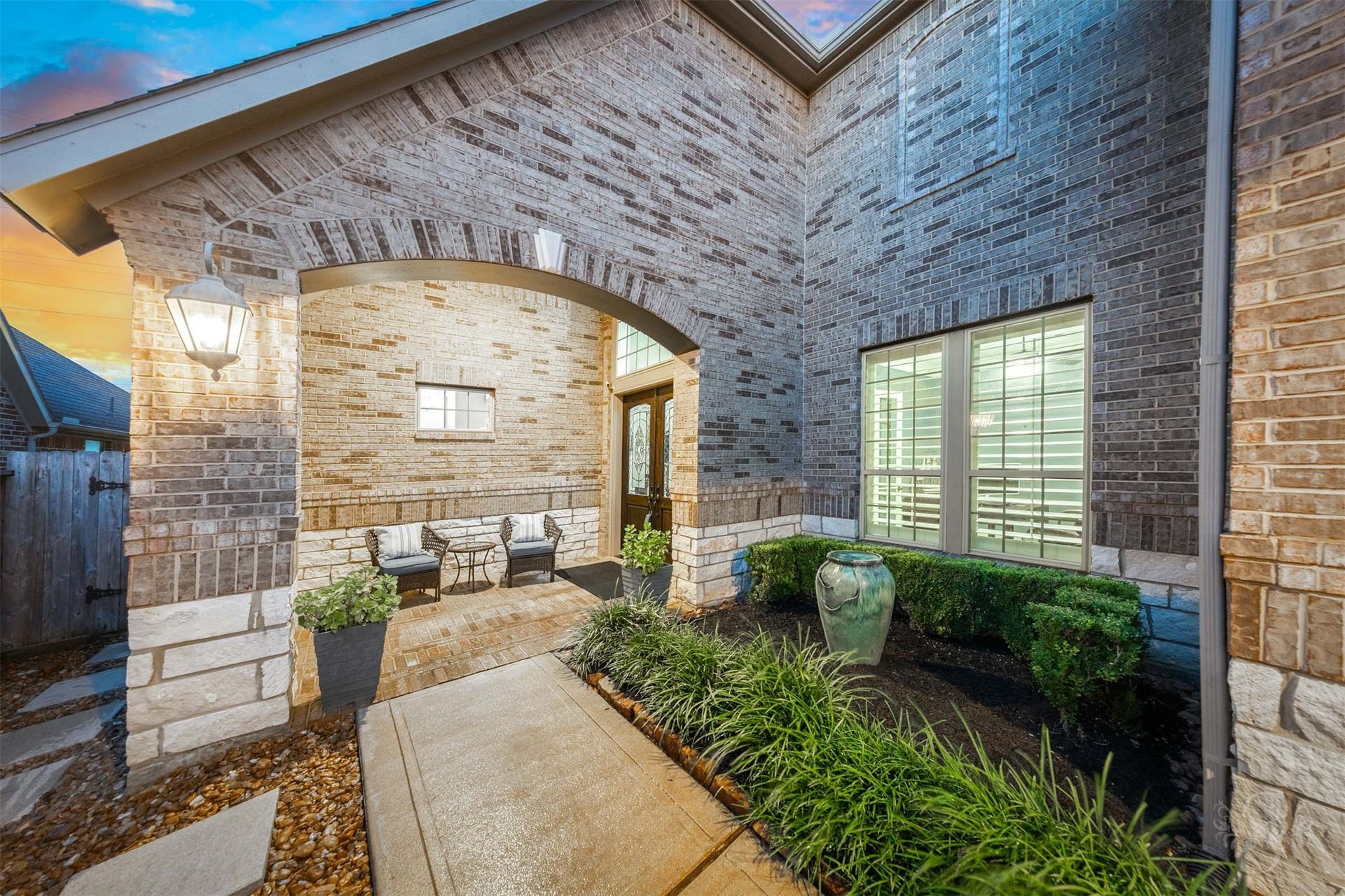 27506 Lakeway Trail Lane, Fulshear, TX 77441 A graceful brick arch and elegant lantern lighting welcome you into the beautifully landscaped front courtyard. The sheltered porch offers a charming place to sit and unwind beside the decorative glass double doors.