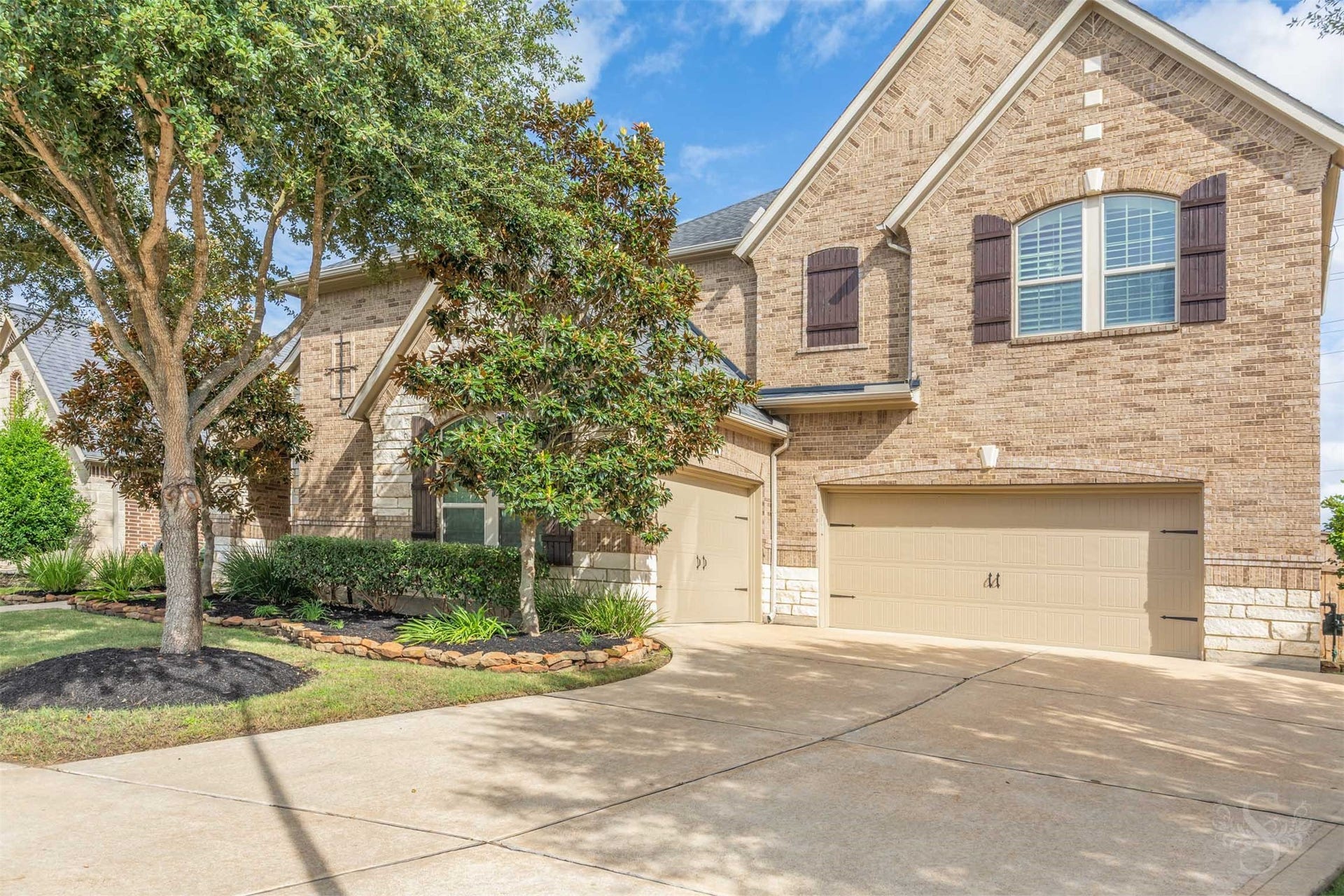 27506 Lakeway Trail Lane, Fulshear, TX 77441 A spacious driveway leads to the 3 car garage, offering generous parking for everyday convenience and welcoming visitors. Rich brick textures, decorative shutters and stone-bordered planting beds carry the homes classic style across the exterior.