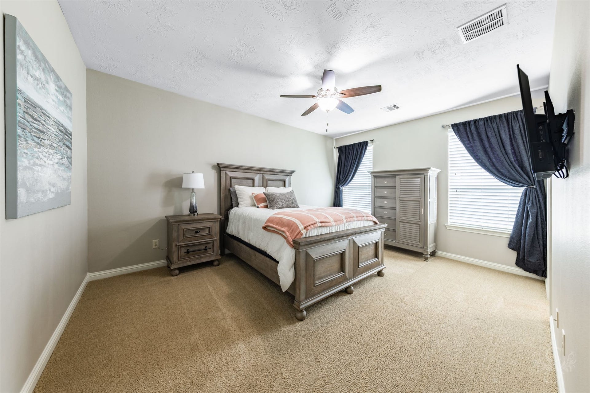27506 Lakeway Trail Lane, Fulshear, TX 77441 This spacious upstairs bedroom offers a bright, welcoming retreat with two large windows and soft neutral finishes. Generous proportions provide comfortable space for bedroom furnishings and a study area.