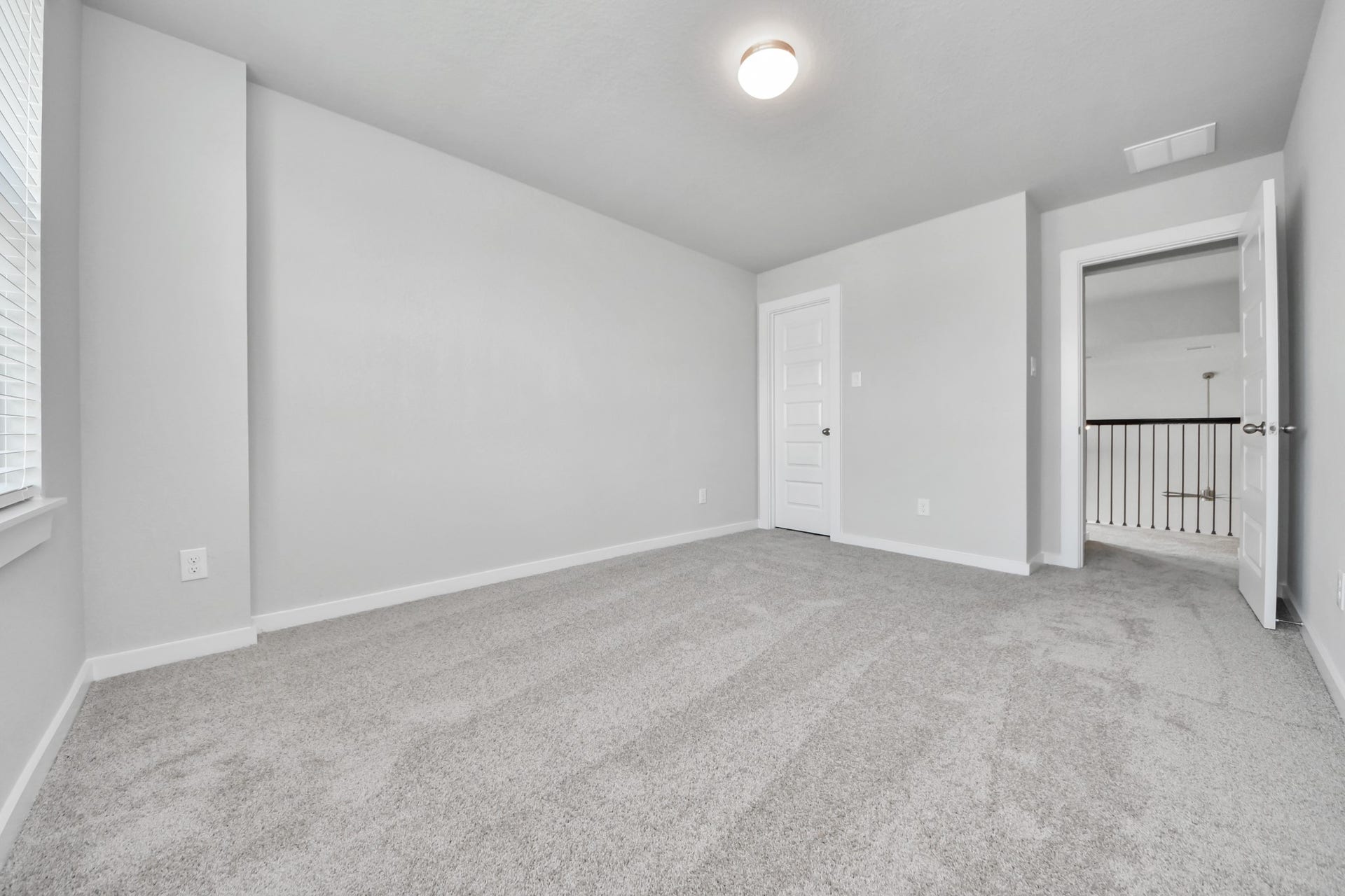 Generously sized secondary bedrooms featuring spacious closets, soft and inviting carpeting underfoot, large windows allowing plenty of natural light, and the added touch of privacy blinds for your personal retreat. Sample photo of completed home with similar floor plan. Actual colors and selections may vary.
