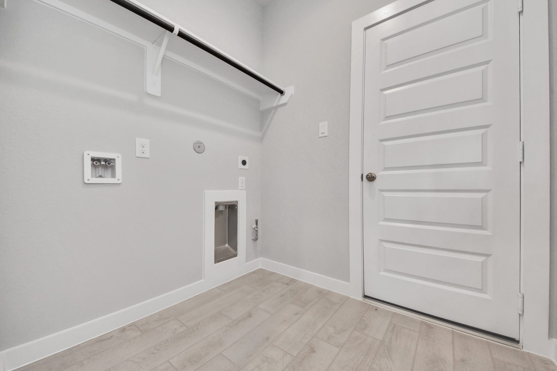 A perfect blend of functionality and comfort. Capture the essence of easy living with a first-floor laundry room, thoughtfully equipped with shelving for effortless organization. Both electric and gas connections available. Sample photo of completed home with similar floor plan. Actual colors and selections may vary.