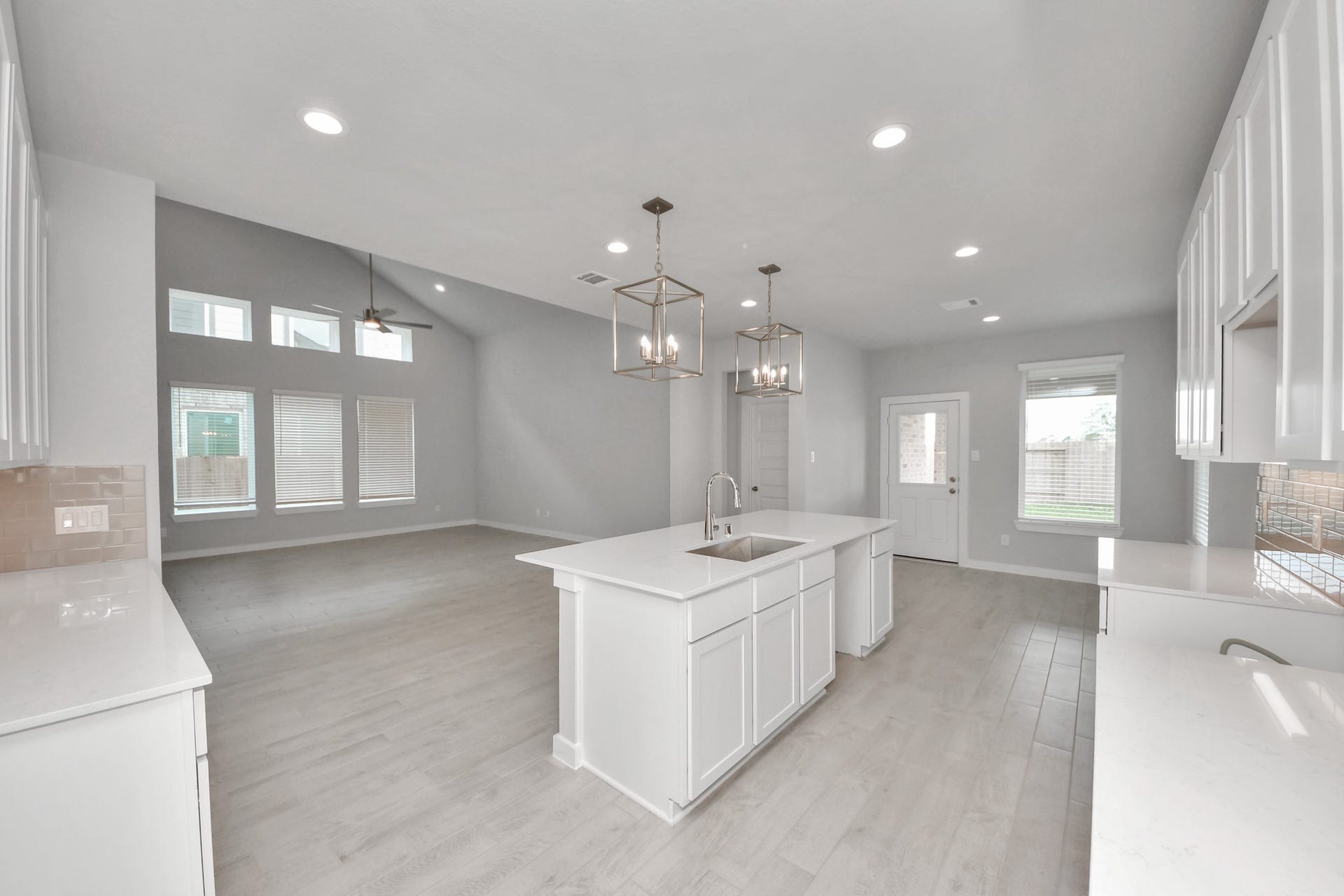 The kitchen is a culinary haven, featuring granite countertops, a tile backsplash, stainless steel appliances, 42 upper cabinets, and undercabinet lighting. Sample photo of completed home with similar floor plan. Actual colors and selections may vary.
