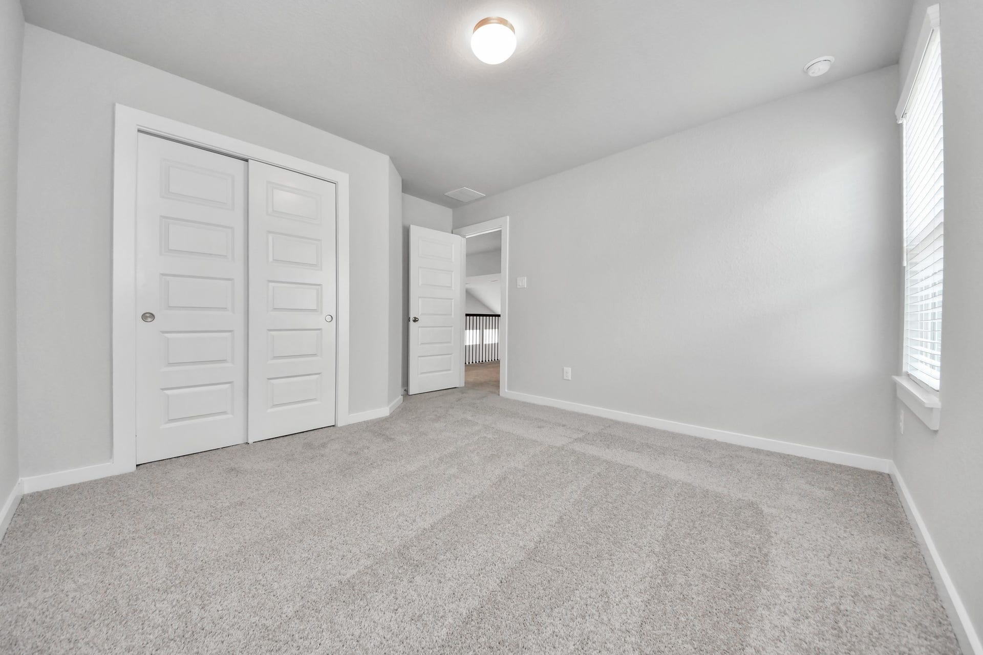 Generously sized secondary bedrooms featuring spacious closets, soft and inviting carpeting underfoot, large windows allowing plenty of natural light, and the added touch of privacy blinds for your personal retreat. Sample photo of completed home with similar floor plan. Actual colors and selections may vary.