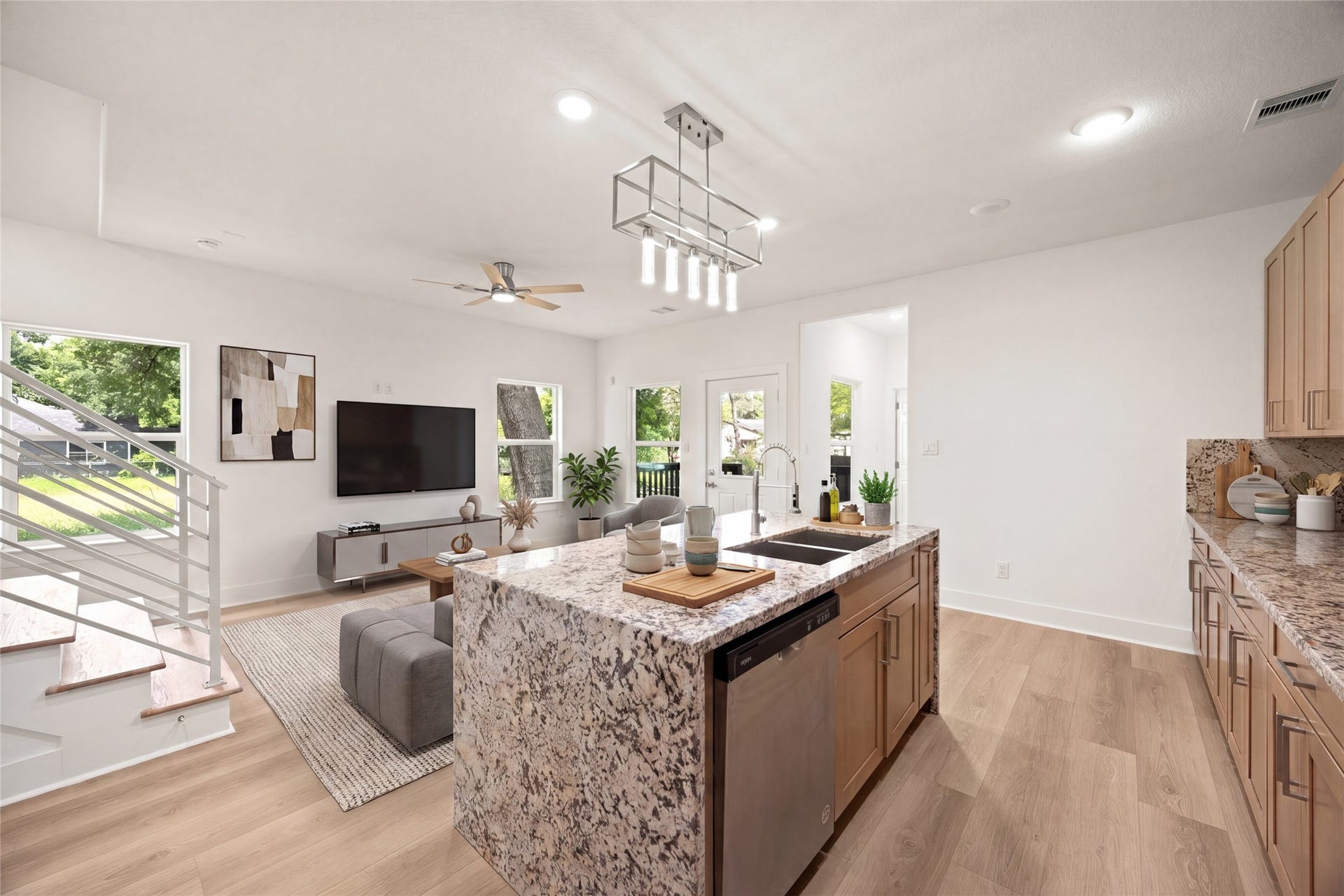 Modern kitchen featuring sleek stainless steel appliances, elegant granite countertops, and ample wooden cabinetry for a warm, inviting atmosphere.